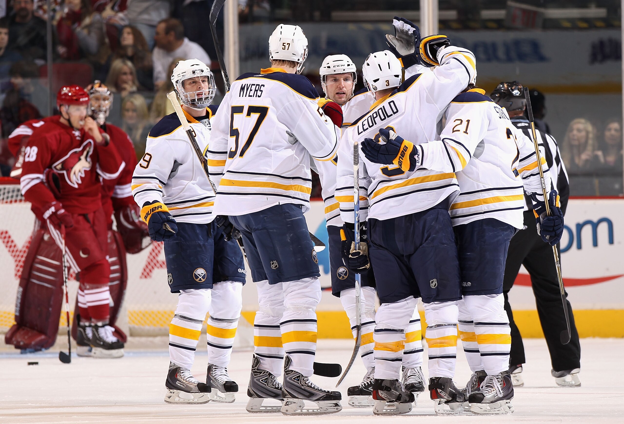 GLENDALE, AZ - JANUARY 08:  Jordan Leopold #3 of the Buffalo Sabres is congratulated by teammates after scoring a second period goal against goaltender Jason LaBarbera #1 of the Phoenix Coyotes during the NHL game at Jobing.com Arena on January 8, 2011 in