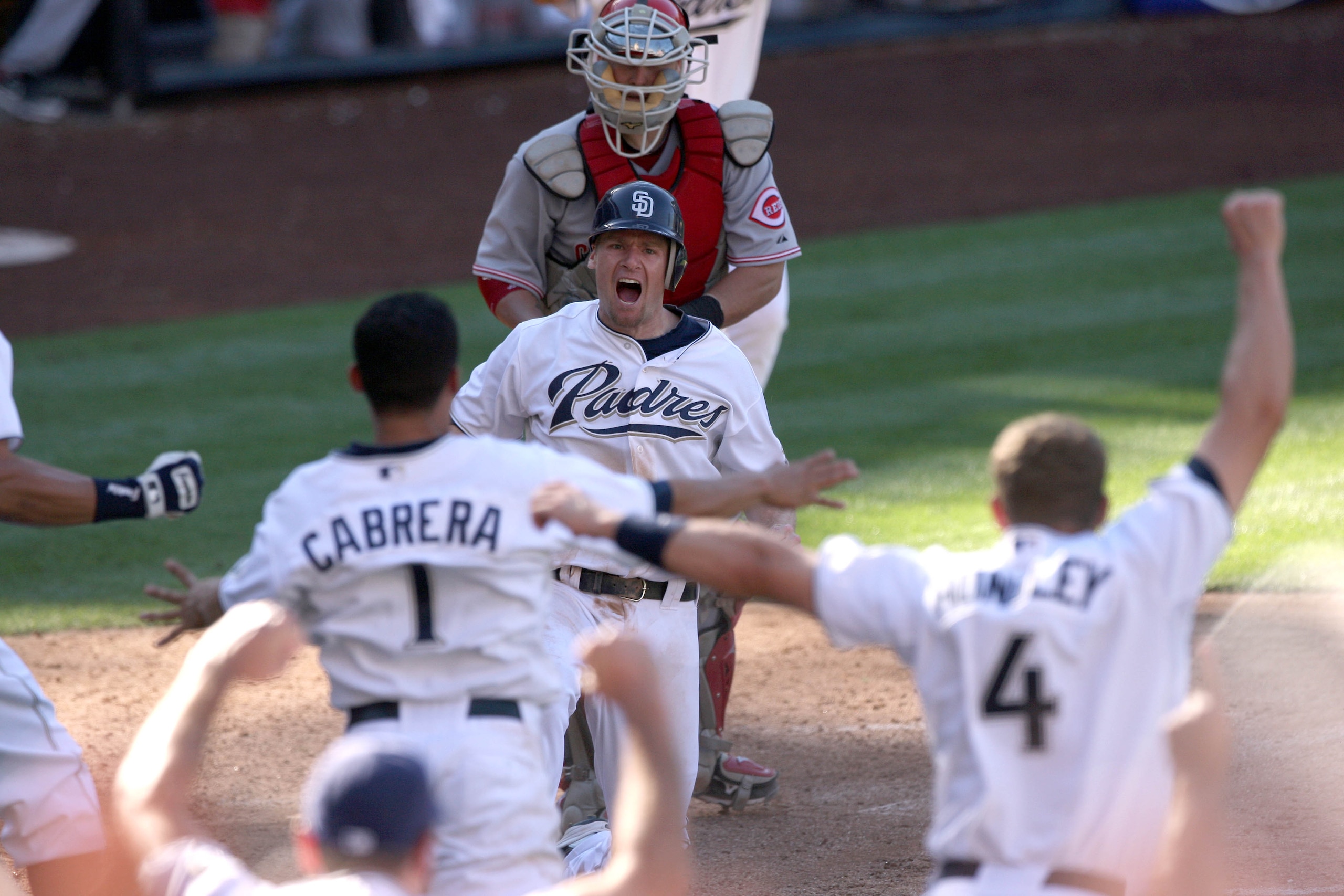 SAN DIEGO, CA - SEPTEMBER 25:  Chase Headley #7 of the San Diego Padres slides past the tag of catcher Ramon Hernandez #55 of Cincinnati Reds for the winning score during the Padres 4-3 win in their MLB game on September 25, 2010 at PETCO Park in San Dieg