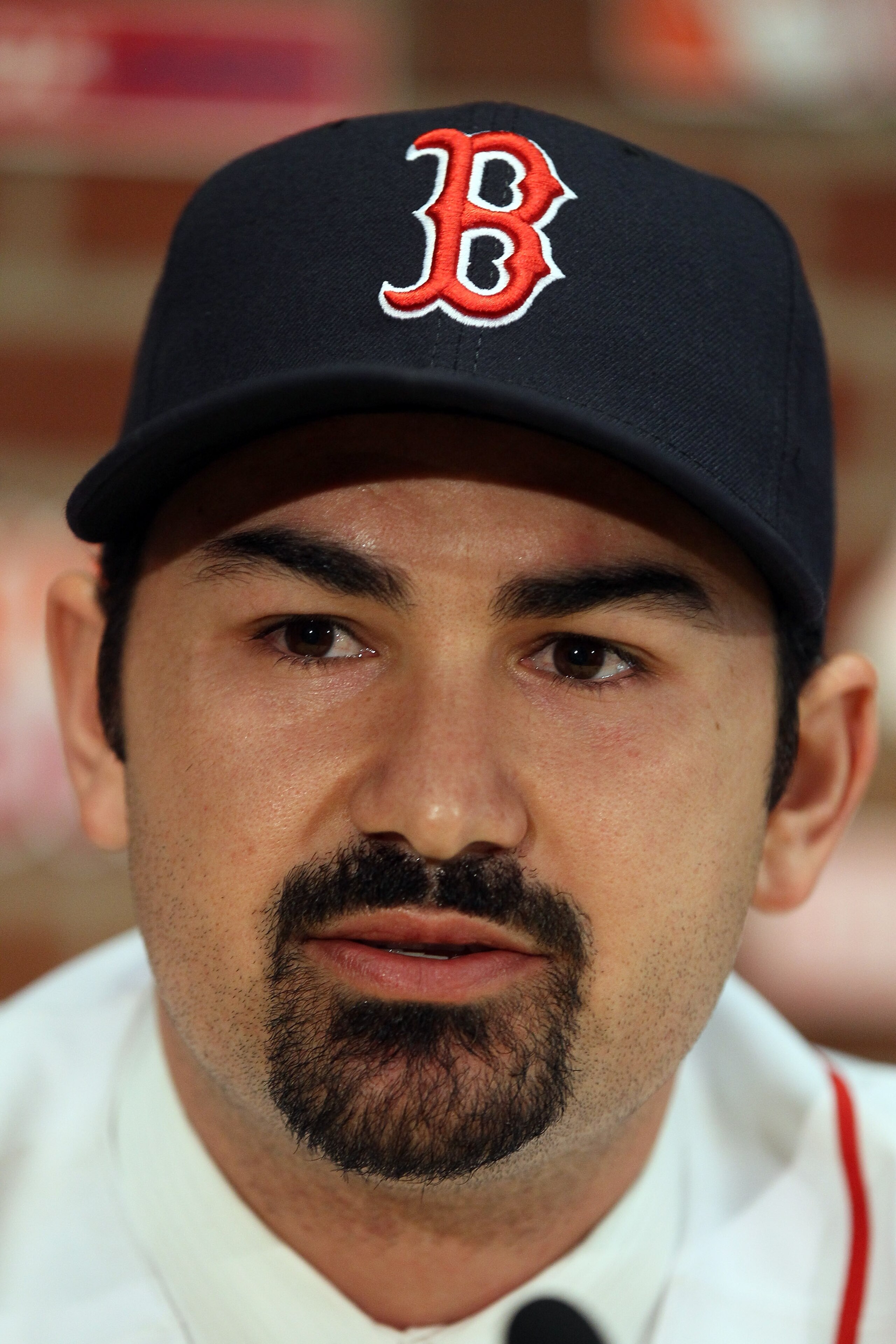 BOSTON, MA - DECEMBER 06:  Adrian Gonzalez answers questions during a press conference to announce his signing with the Boston Red Sox on December 6,  2010 at Fenway Park in Boston, Massachusetts.  (Photo by Elsa/Getty Images)