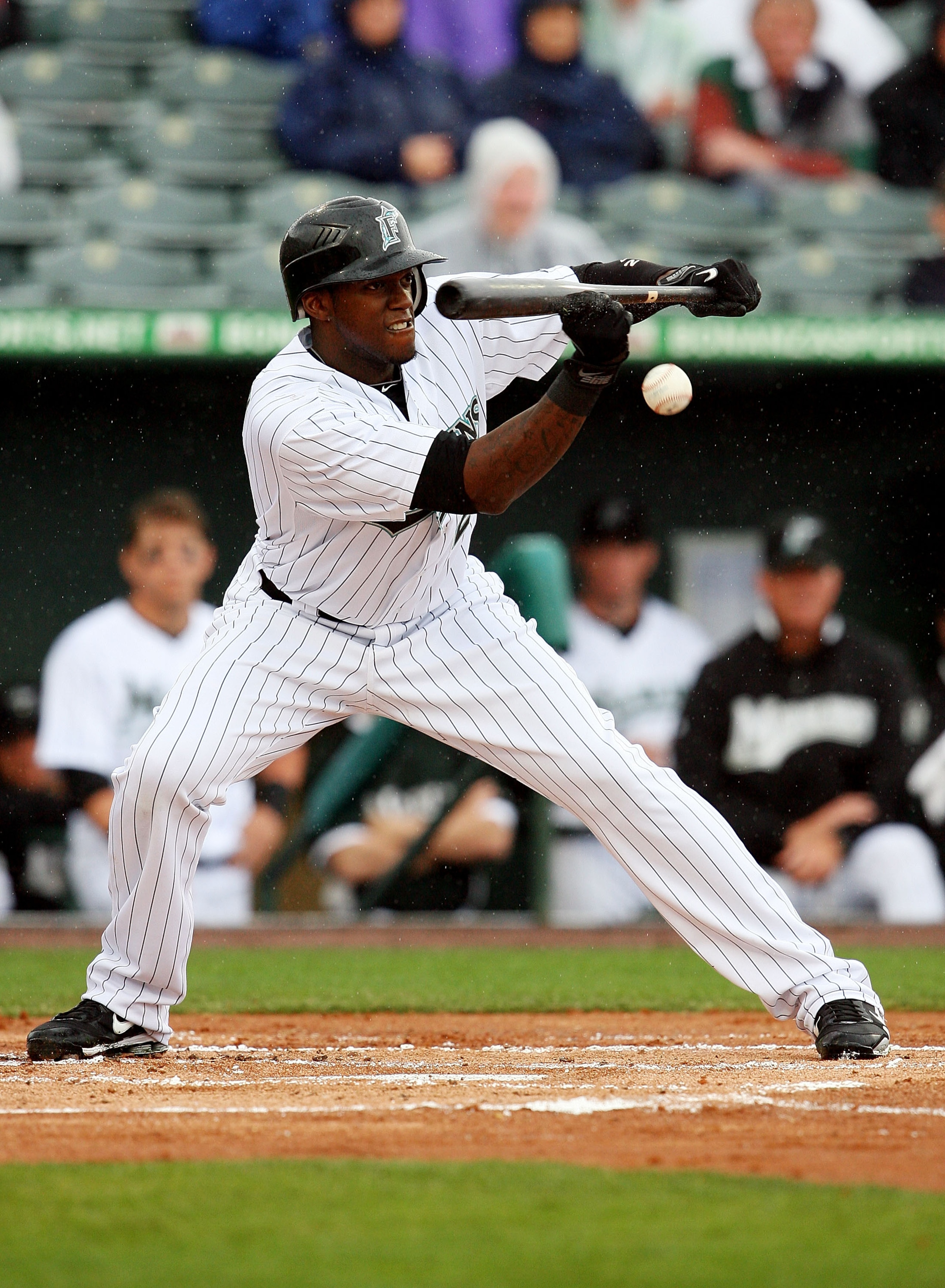 JUPITER, FL - MARCH 17:  Outfielder Cameron Maybin #24 of the Florida Marlins lays down a sacrifice bunt against the Atlanta Braves at Roger Dean Stadium on March 17, 2010 in Jupiter, Florida.  (Photo by Doug Benc/Getty Images)
