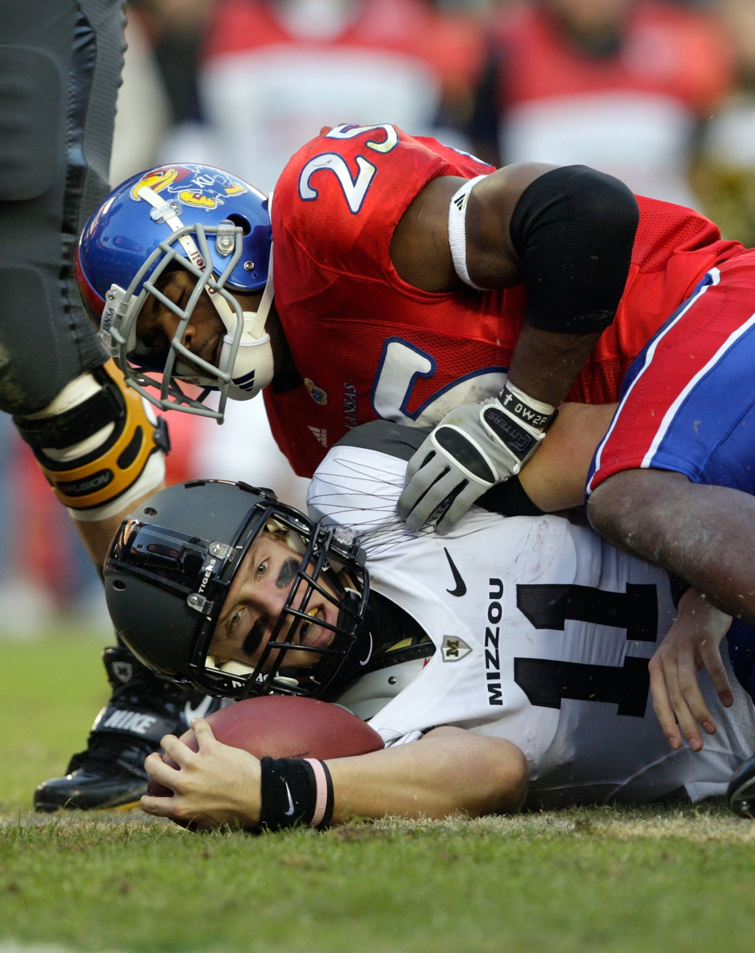 KANSAS CITY, MO - NOVEMBER 28: Quarterback Blaine Gabbert #11 of the Missouri Tigers is tackled short of the end zone by Darrell Stuckey #25 of the Kansas Jayhawks during the game at Arrowhead Stadium on November 28, 2009 in Kansas City, Missouri. (Photo