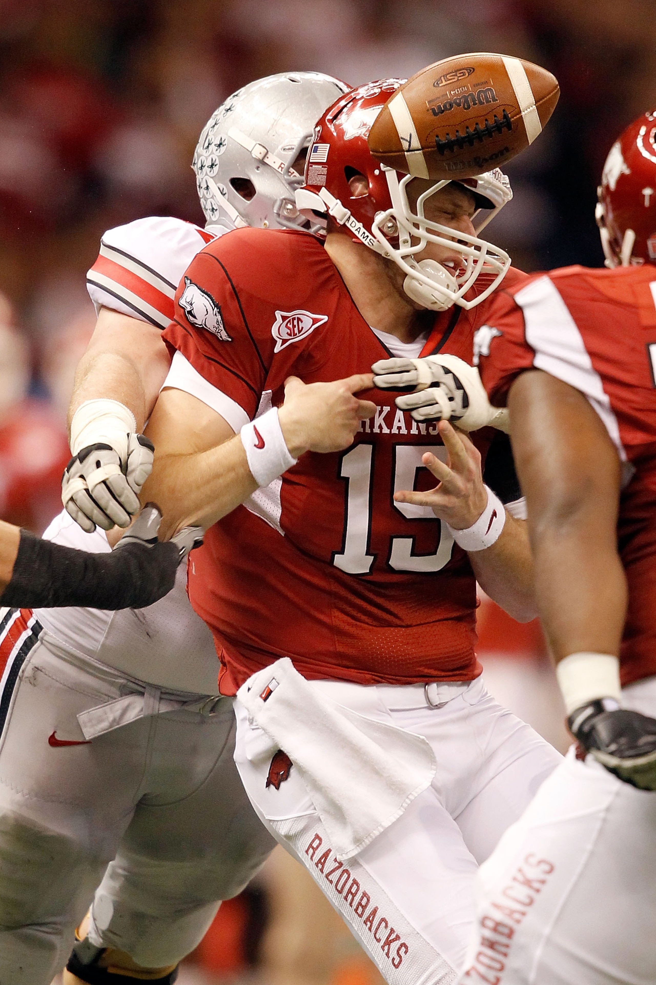 NEW ORLEANS, LA - JANUARY 04: Ryan Mallett #15 of the Arkansas Razorbacks is hit by Dexter Larimore #72 of the Ohio State Buckeyes and loses the football in the second quarter during the Allstate Sugar Bowl at the Louisiana Superdome on January 4, 2011 in