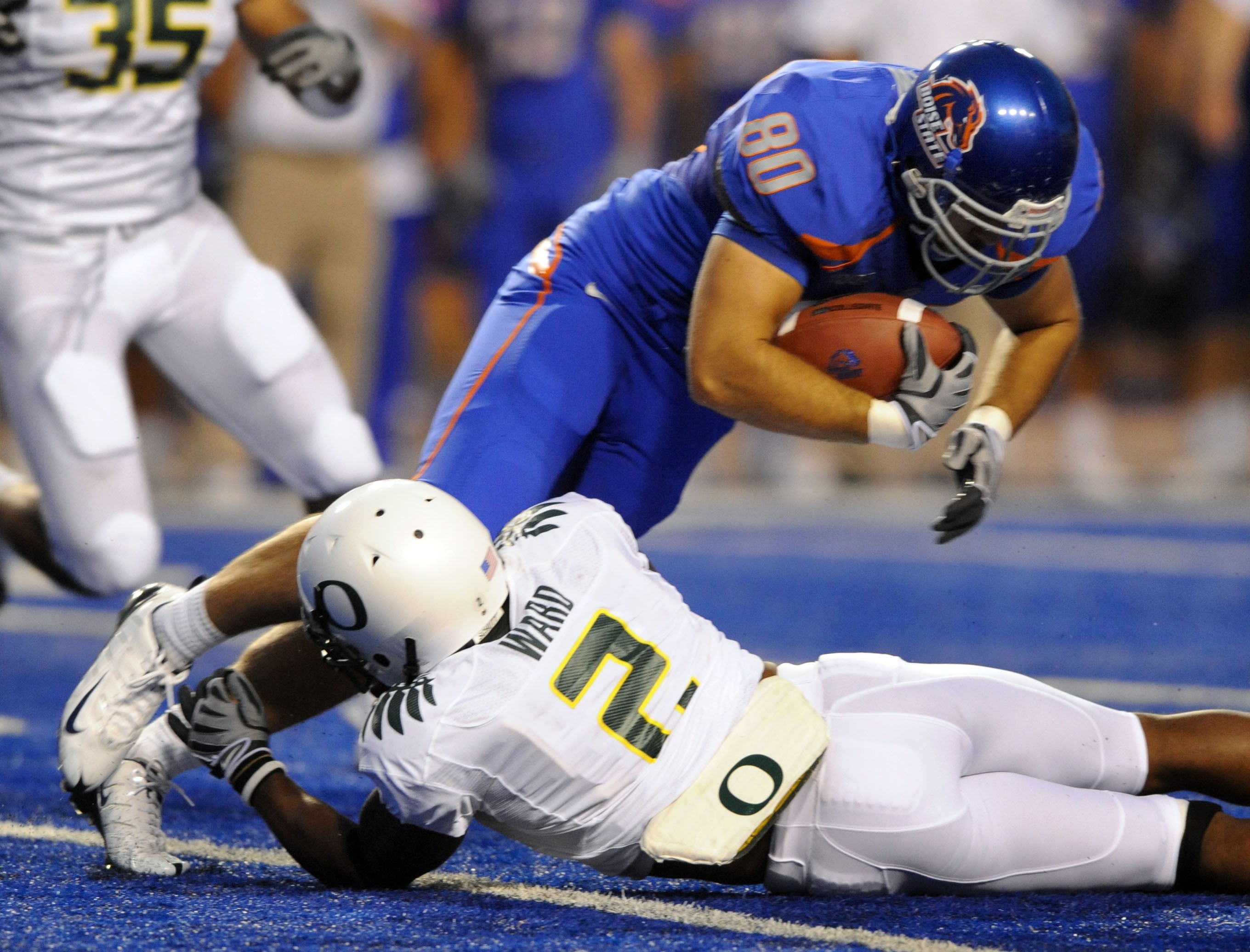 BOISE, ID - SEPTEMBER 3: Safety T.J Ward #2 of the Oregon Ducks  tackles tight end Kyle Efaw #80 of the Boise State Broncos in the second quarter of the game on September 3, 2009 at Bronco Stadium in Boise, Idaho. Boise State won the game 19-8. (Photo by
