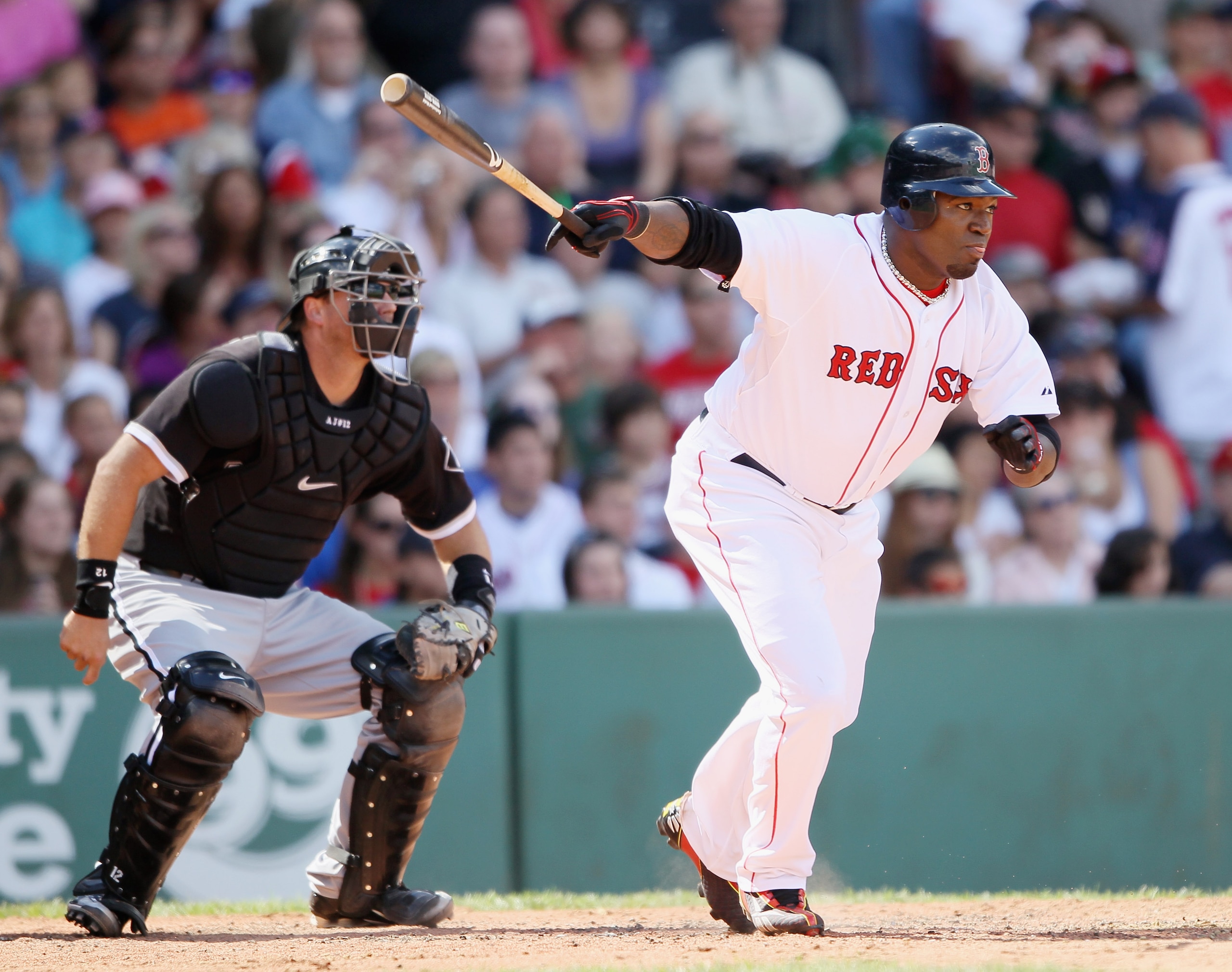 BOSTON - SEPTEMBER 05:  David Ortiz #34 of the Boston Red Sox hits a 2RBI double in the third inning as A.J. Pierzynski #12 the Chicago White Sox defends on September 5, 2010 at Fenway Park in Boston, Massachusetts.  (Photo by Elsa/Getty Images)