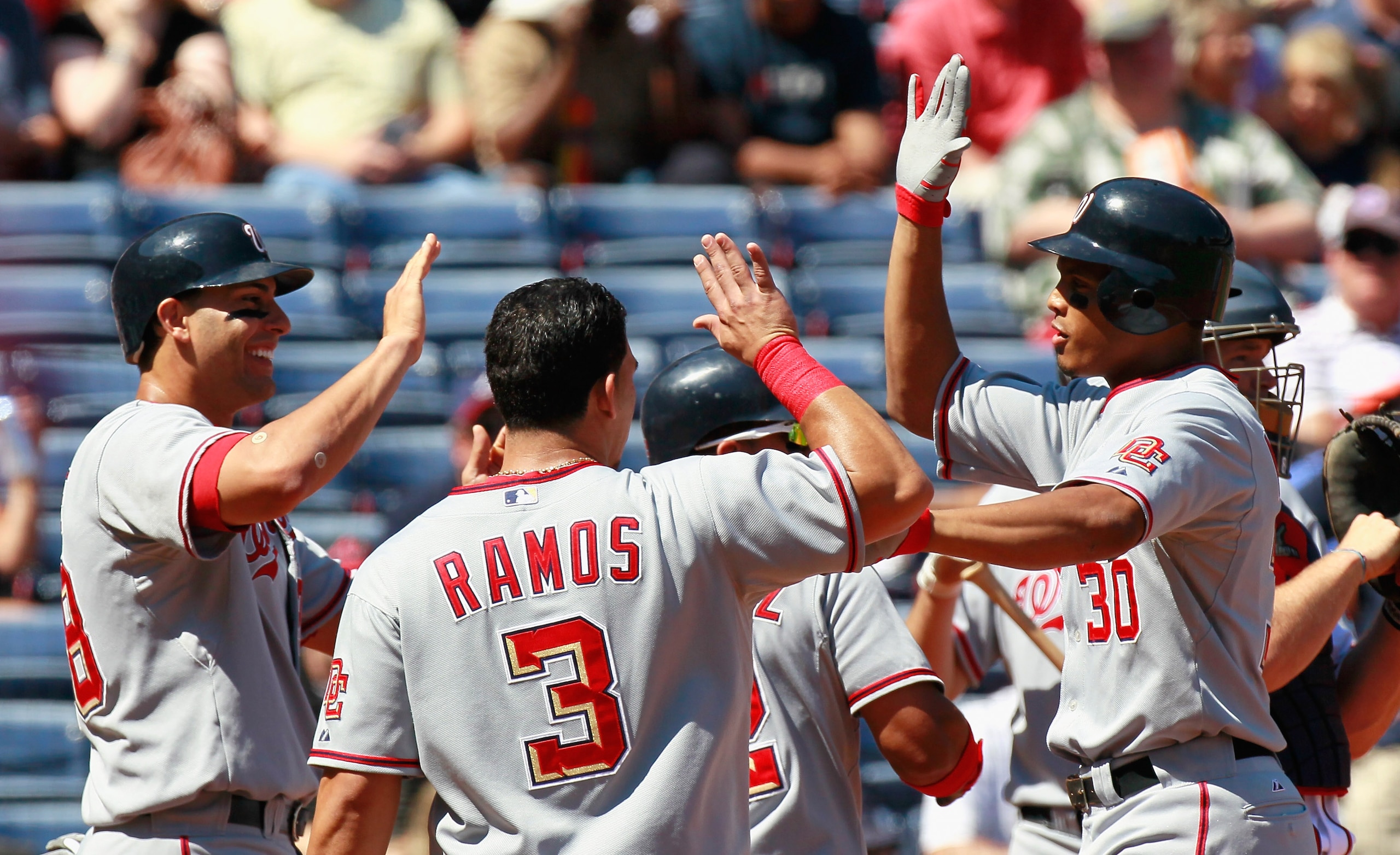 ATLANTA - SEPTEMBER 15:  Justin Maxwell #30 of the Washington Nationals celebrates his grand slam in the second inning against the Atlanta Braves with Mike Morse #28 and Wilson Ramos #3 at Turner Field on September 15, 2010 in Atlanta, Georgia.  (Photo by