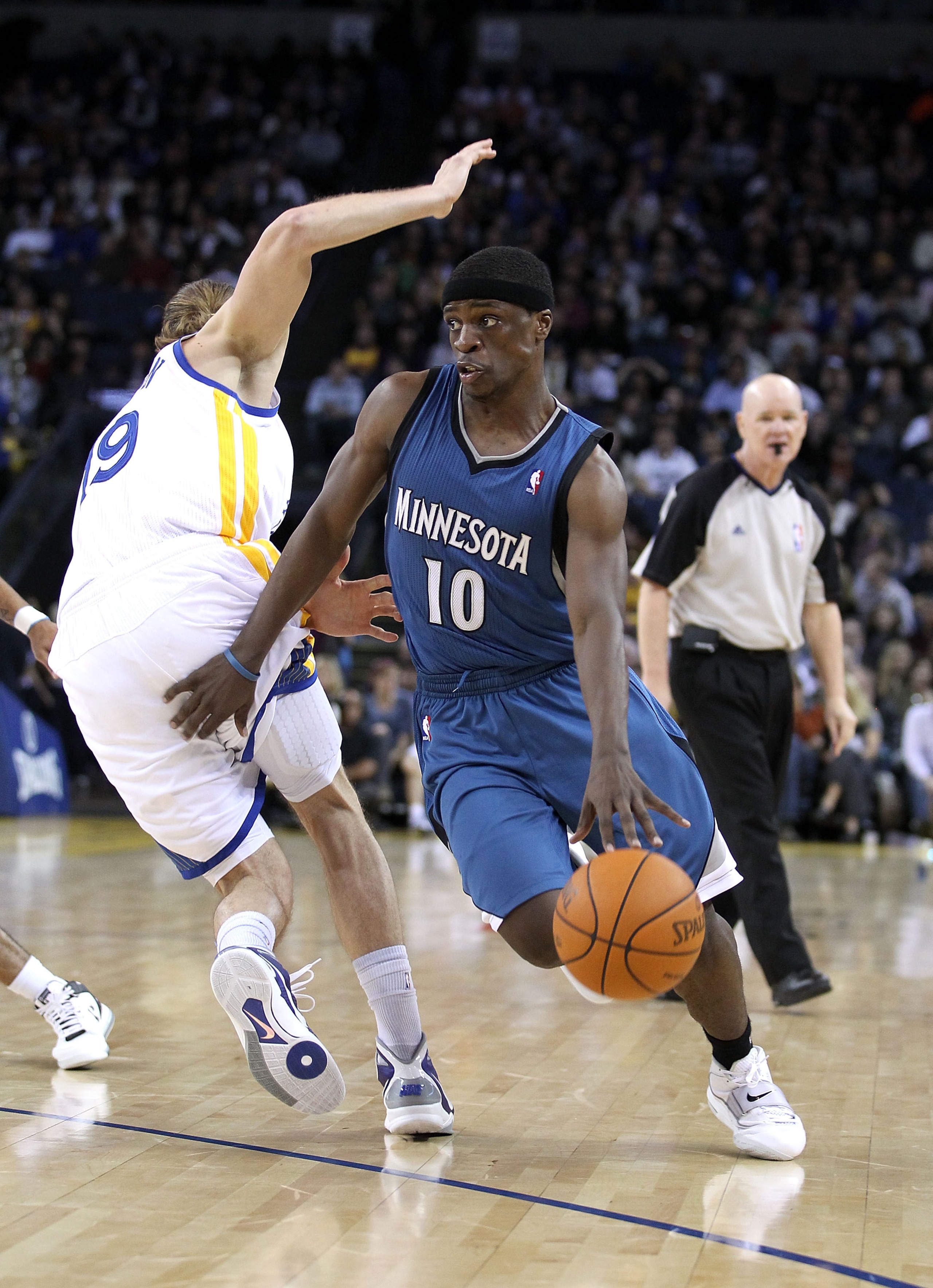 OAKLAND, CA - DECEMBER 14:  Jonny Flynn #10 of the Minnesota Timberwolves dribbles past Lou Amundson #19 of the Golden State Warriors at Oracle Arena on December 14, 2010 in Oakland, California.  NOTE TO USER: User expressly acknowledges and agrees that,