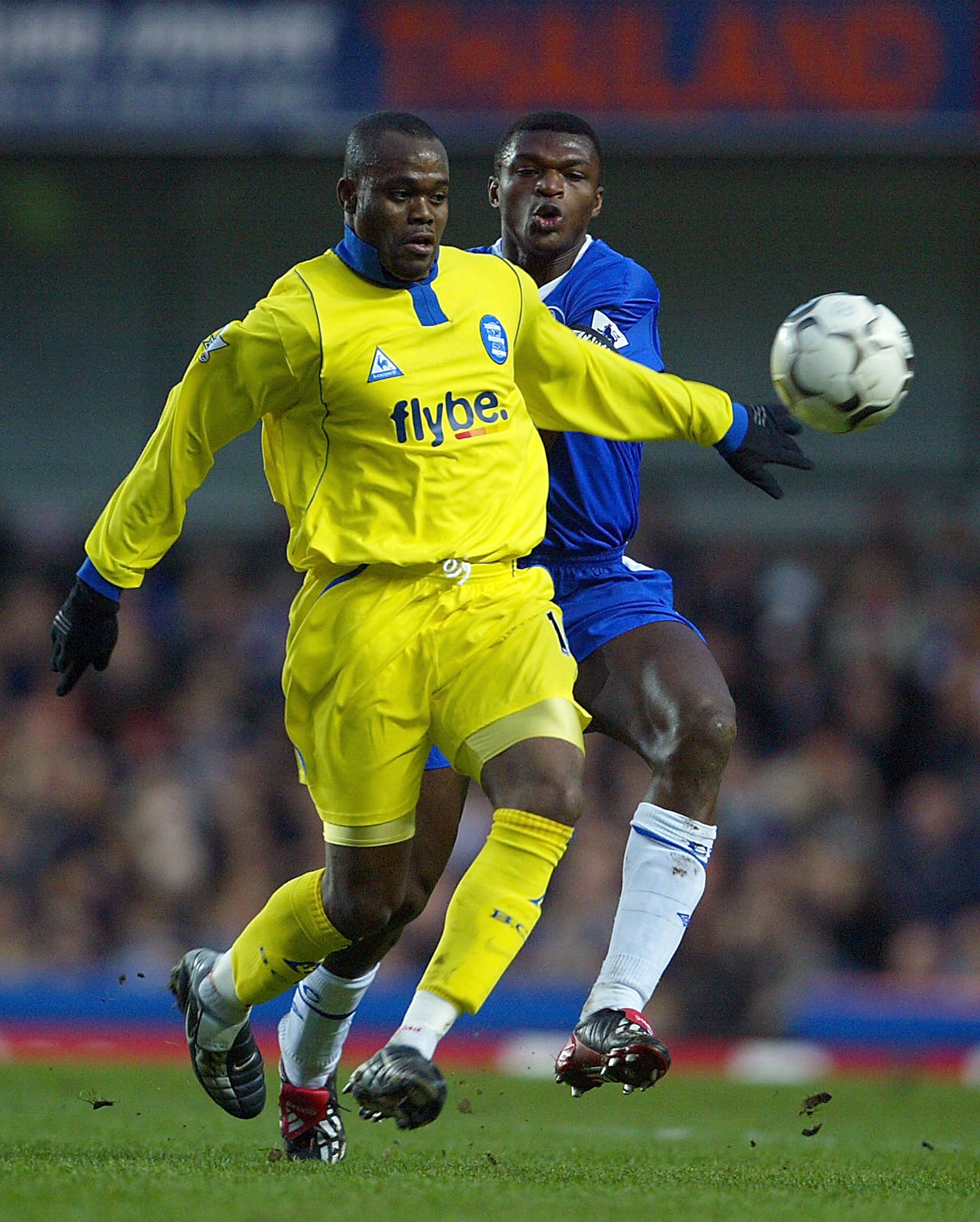 LONDON - JANUARY 18: Marcel Desailly of Chelsea tries to tackle Stern John of Birmingham City during the FA Barclaycard Premiership match between Chelsea and Birmingham City at Stamford Bridge on January 18, 2004 in London.  (Photo by Phil Cole/Getty Imag