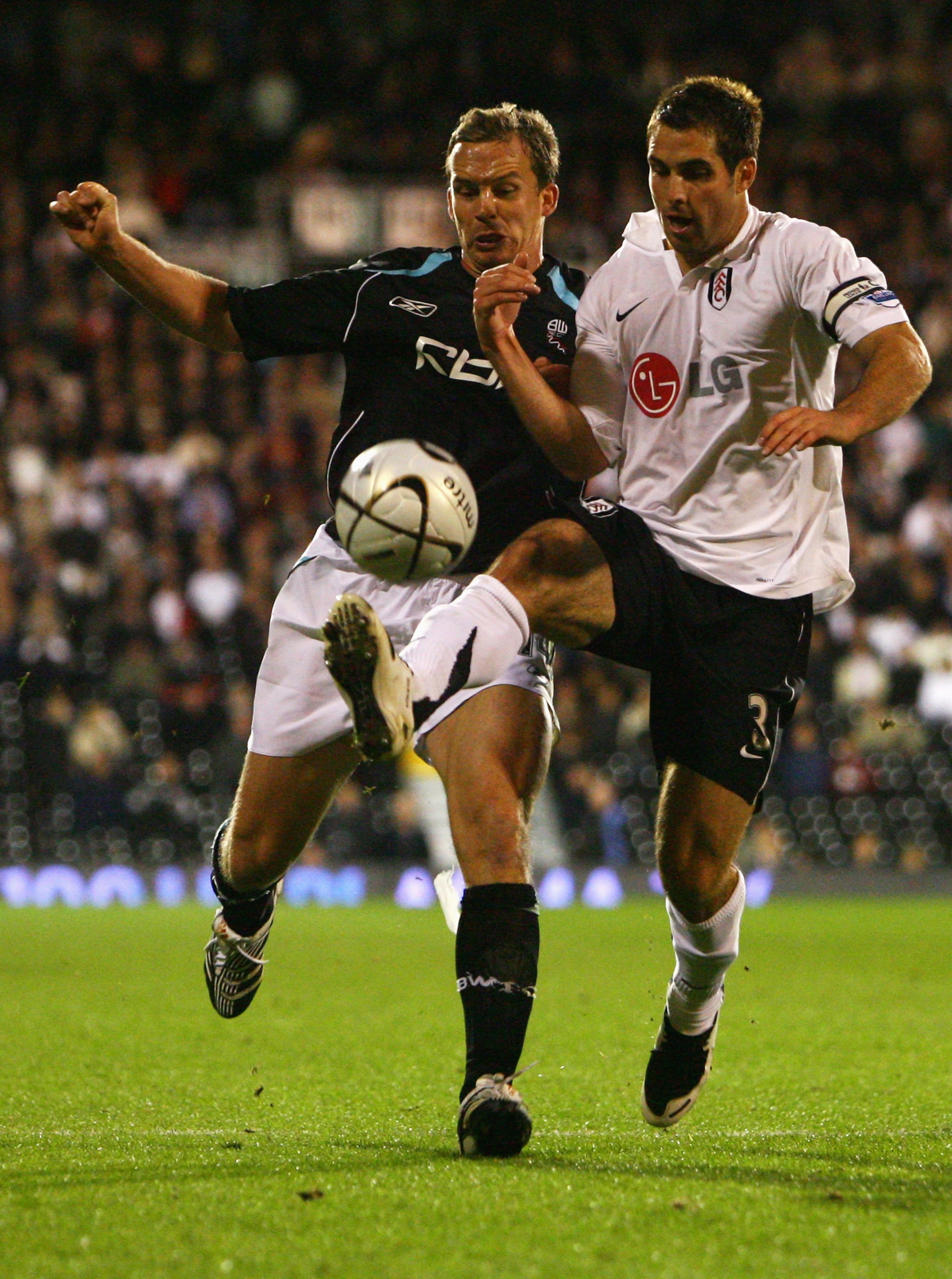 LONDON - SEPTEMBER 26:  Kevin Davies of Bolton Wanderers (L) battles with Carlos Bocanegra of Fulham during the Carling Cup Third Round match between Fulham and Bolton Wanderers at Craven Cottage on September 26, 2007 in London, England.  (Photo by Ryan P