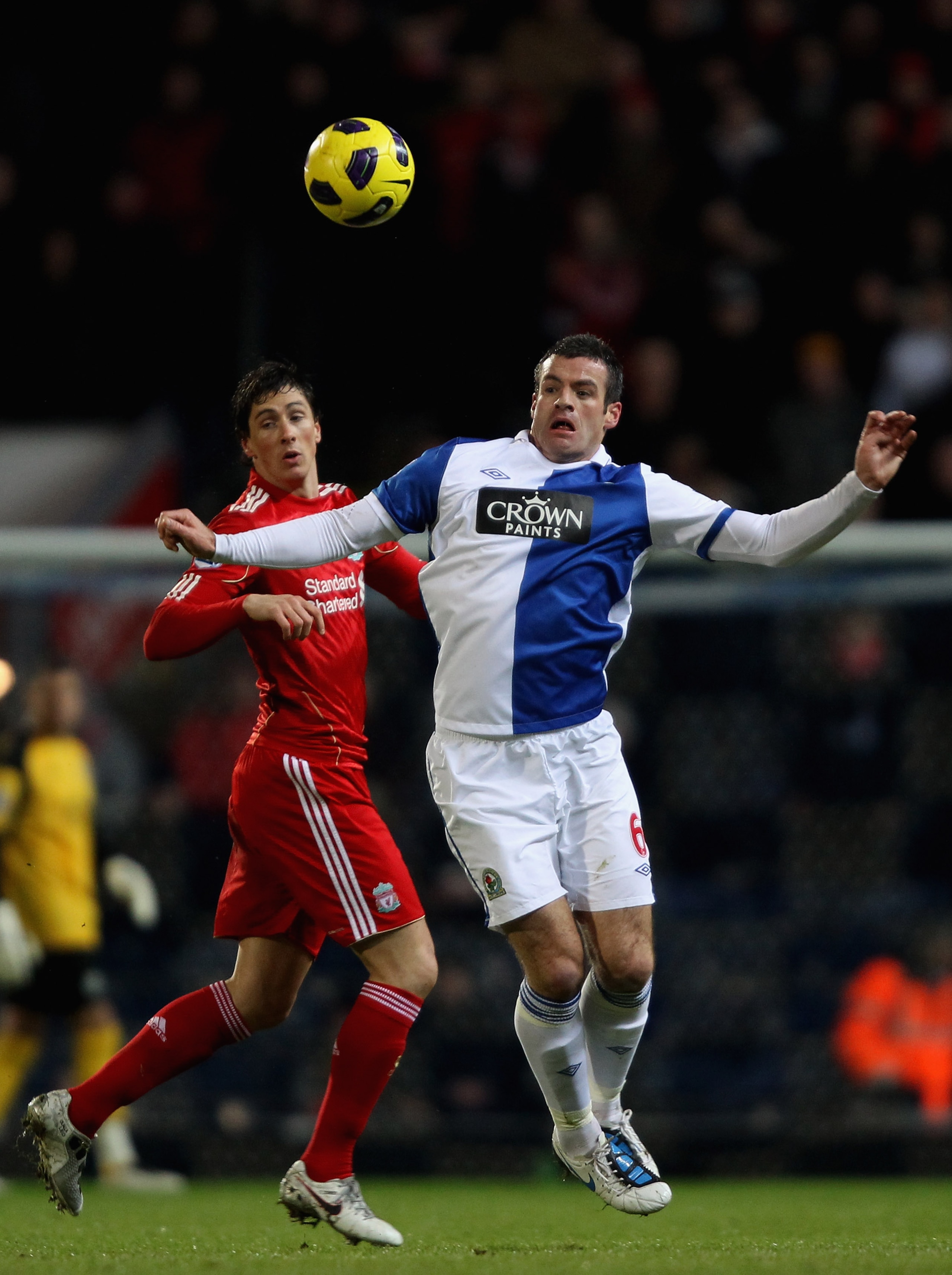 BLACKBURN, ENGLAND - JANUARY 05:  Ryan Nelsen of Blackburn Rovers heads the ball away from Fernando Torres of Liverpool during the Barclays Premier League match between Blackburn Rovers and Liverpool at Ewood park on January 5, 2011 in Blackburn, England.