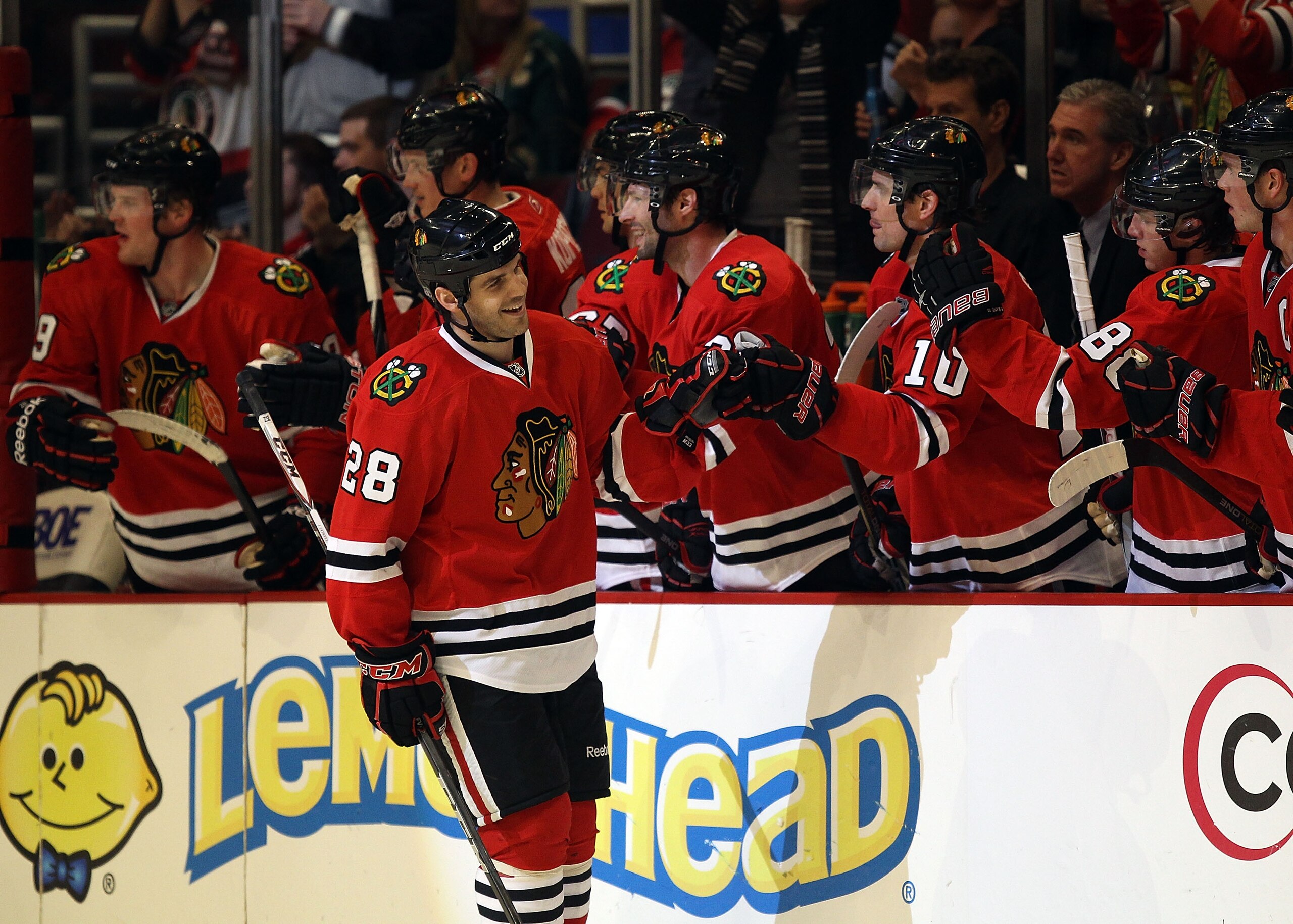 CHICAGO, IL - FEBRUARY 16: Jake Dowell #28 of the Chicago Blackhawks is congratulated by teammates after scoring a goal against the Minnesota Wild at the United Center on February 16, 2011 in Chicago, Illinois. The Blackhawks defeated the Wild 3-1. (Photo