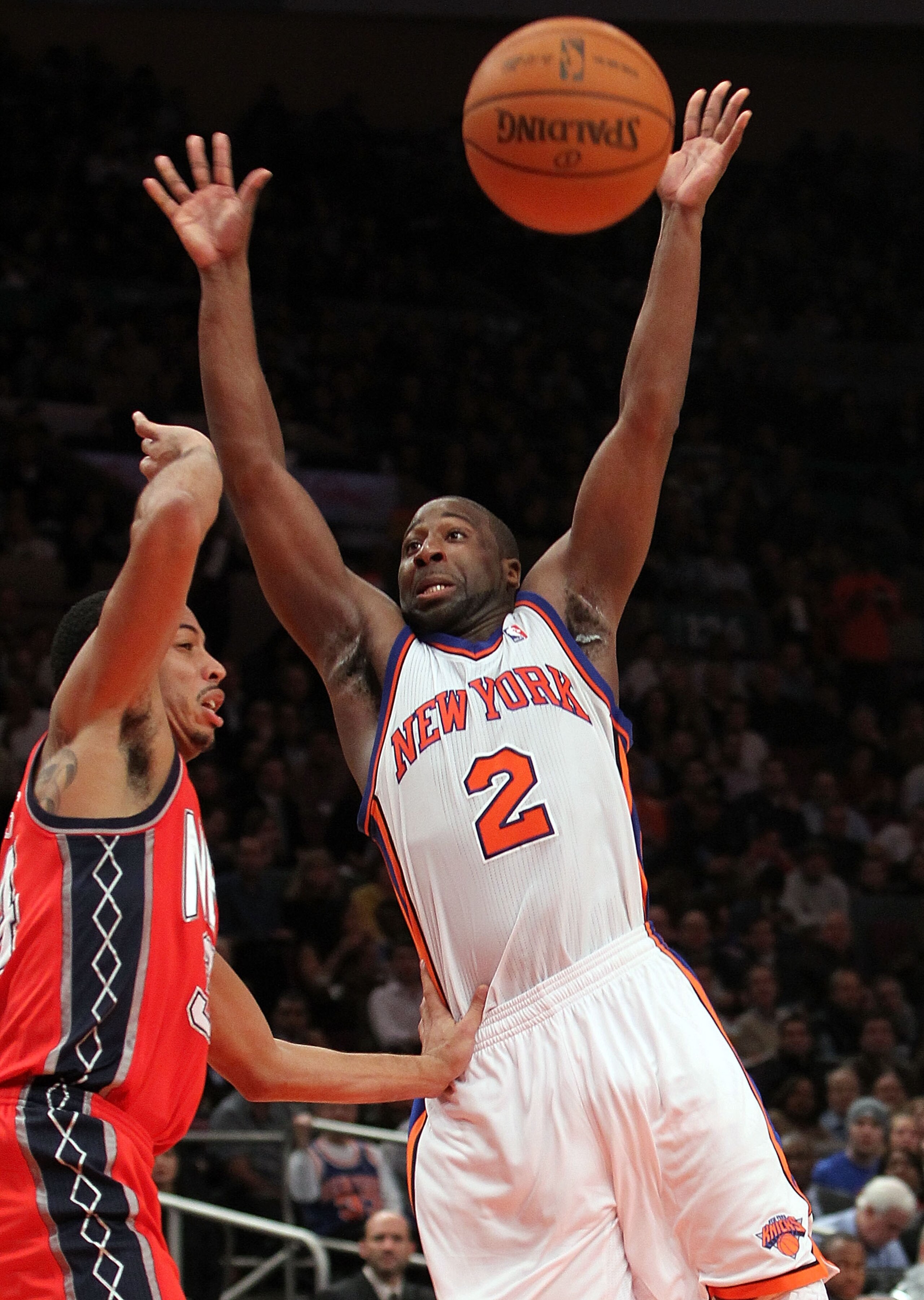 NEW YORK, NY - NOVEMBER 30:  Raymond Felton #2 of the New York Knicks loses possession of the ball against Devin Harris #34 of the New Jersey Nets on November 30, 2010 at Madison Square Garden in New York City. NOTE TO USER: User expressly acknowledges an