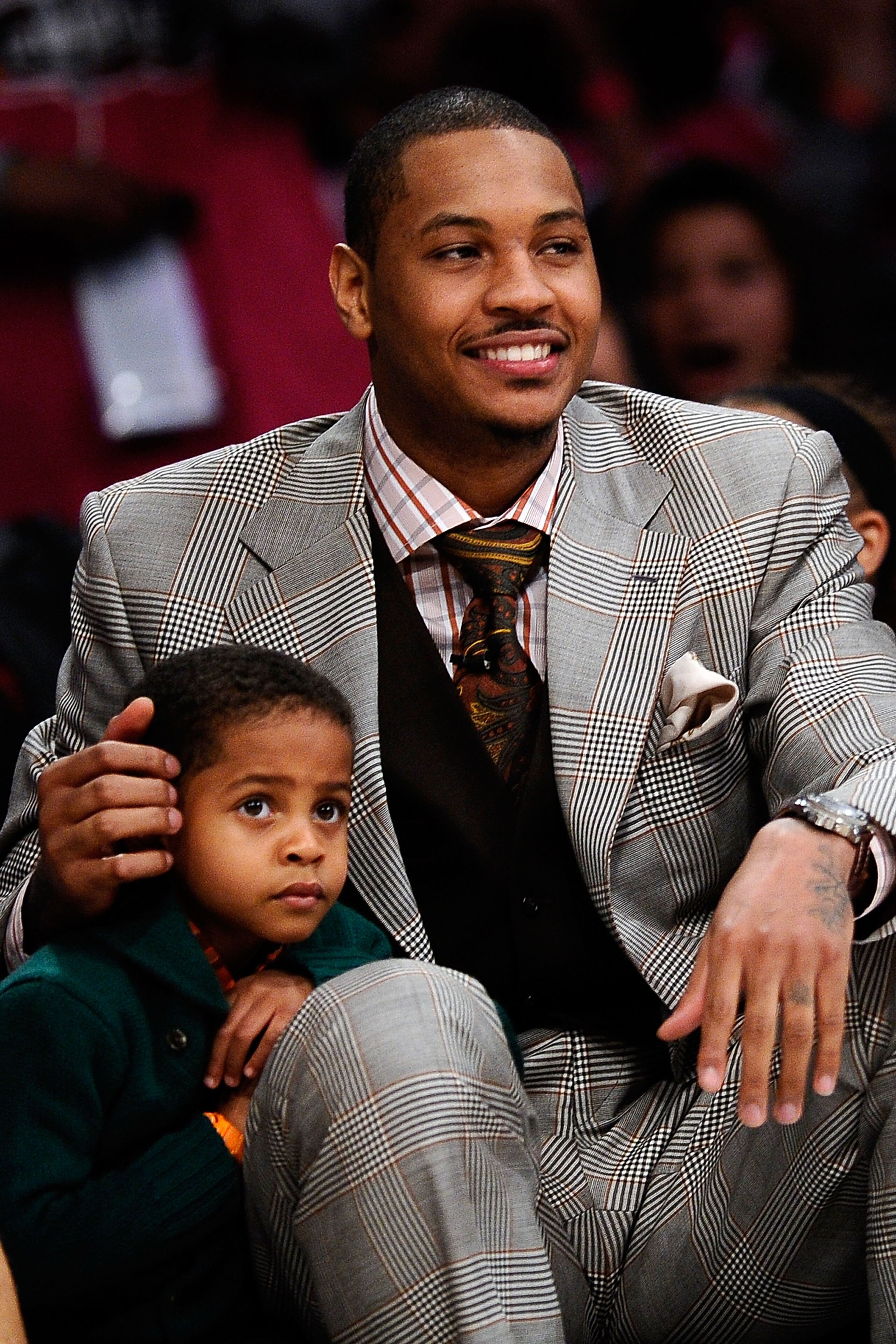 LOS ANGELES, CA - FEBRUARY 18:  Carmelo Anthony of the Denver Nuggets sits with his son Kiyan Carmelo Anthony during the T-Mobile Rookie Challenge and Youth Jam at Staples Center on February 18, 2011 in Los Angeles, California.  (Photo by Kevork Djansezia