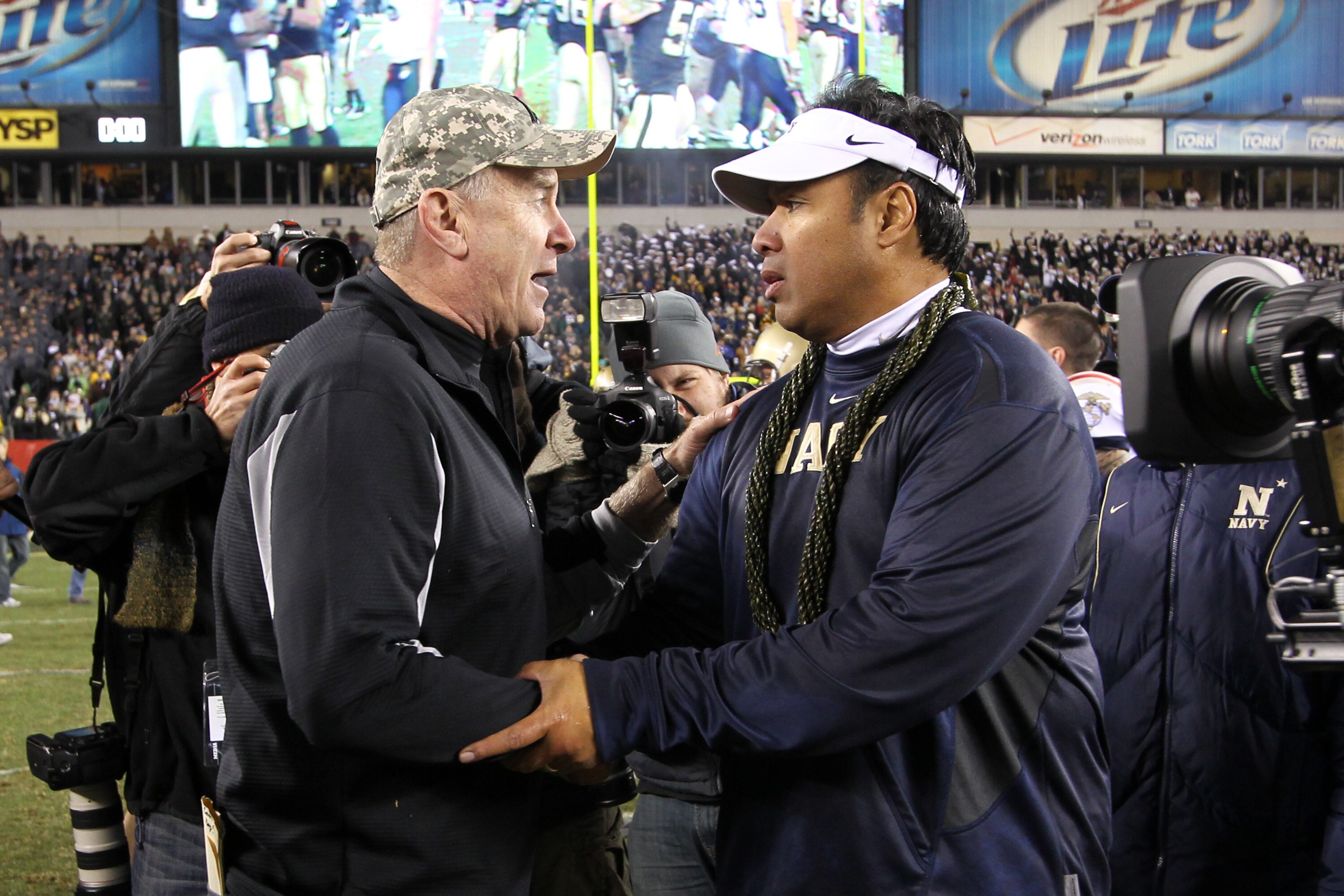 PHILADELPHIA - DECEMBER 11: Head coach Rich Ellerson of the Army Black Knights (L) shakes hands with head coach Ken Niumatalolo of the Navy Midshipmen after a game on December 11, 2010 at Lincoln Financial Field in Philadelphia, Pennsylvania. (Photo by Hu