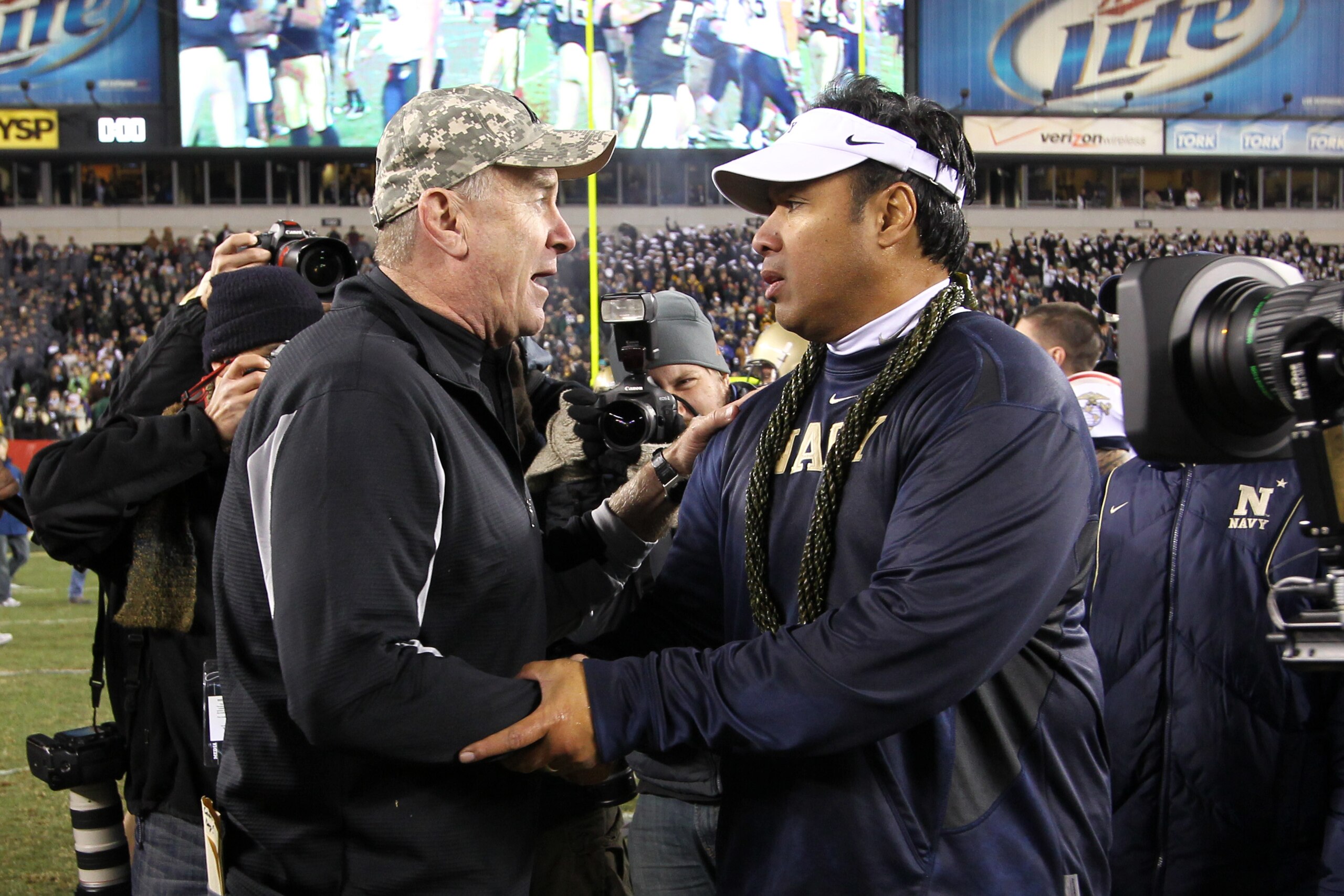 PHILADELPHIA - DECEMBER 11: Head coach Rich Ellerson of the Army Black Knights (L) shakes hands with head coach Ken Niumatalolo of the Navy Midshipmen after a game on December 11, 2010 at Lincoln Financial Field in Philadelphia, Pennsylvania. (Photo by Hu