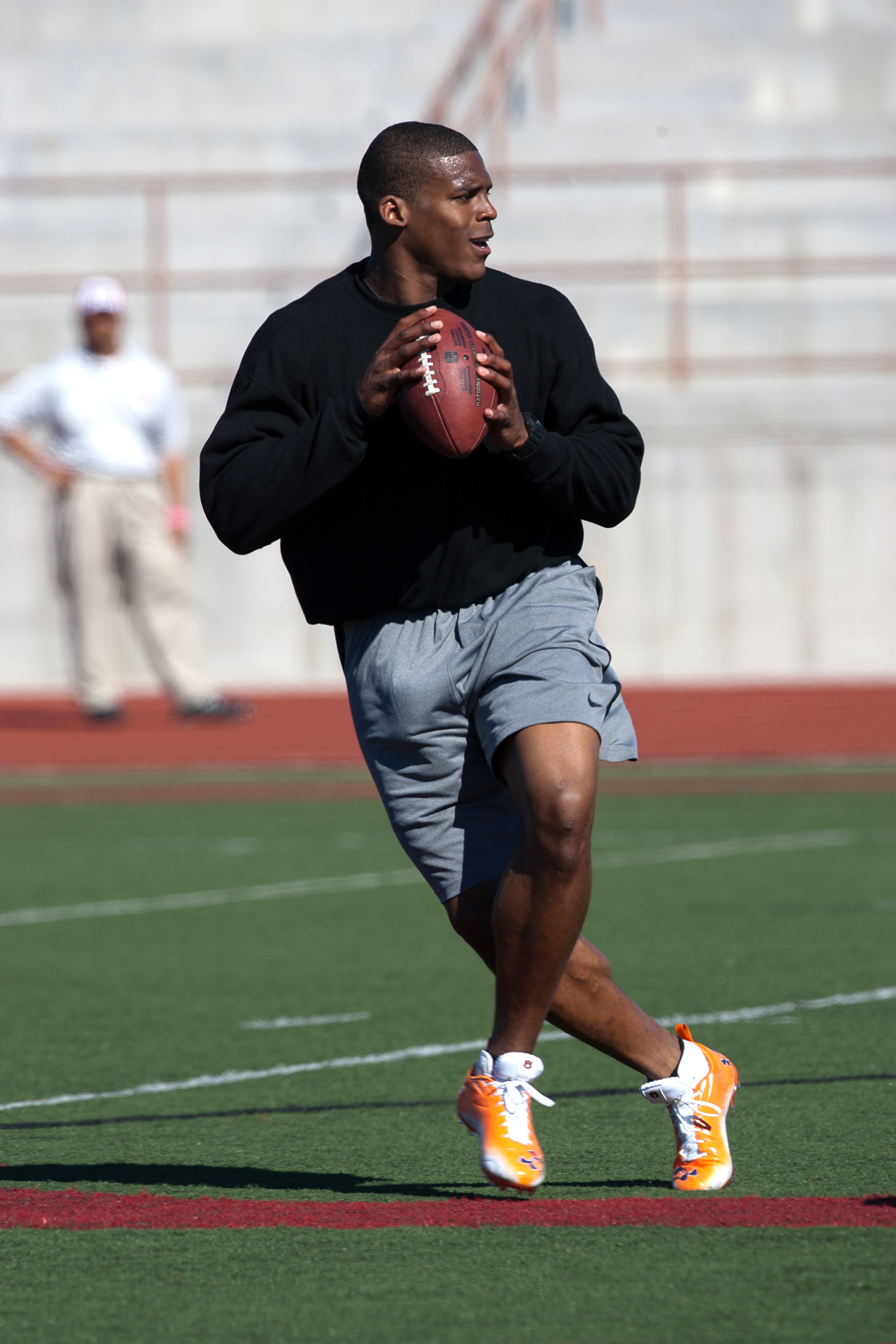 SAN DIEGO, CA - FEBRUARY 10:  2010 Heisman Trophy winning quarterback Cam Newton of the Auburn Tigers goes through his workout routine for the media at Cathedral High School's sports stadium on February 10, 2011 in San Diego, California.  (Photo by Kent H