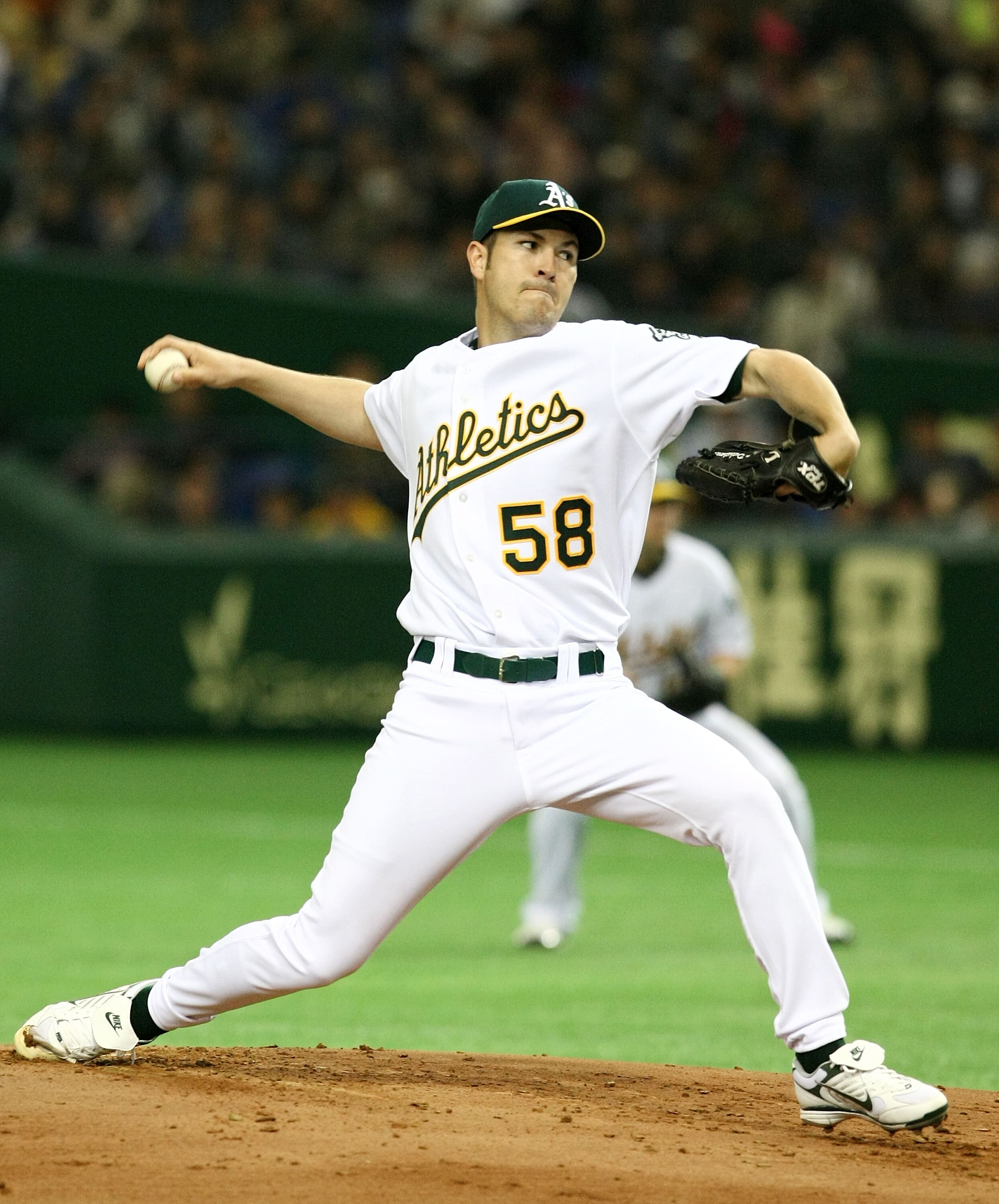 TOKYO - MARCH 23:  Justin Duchscherer #58 of Oakland Athletics pitches during a preseason friendly game between the Oakland Athletics and the Hanshin Tigers at the Tokyo Dome on March 23, 2008 in Tokyo, Japan.  (Photo by Junko Kimura/Getty Images)