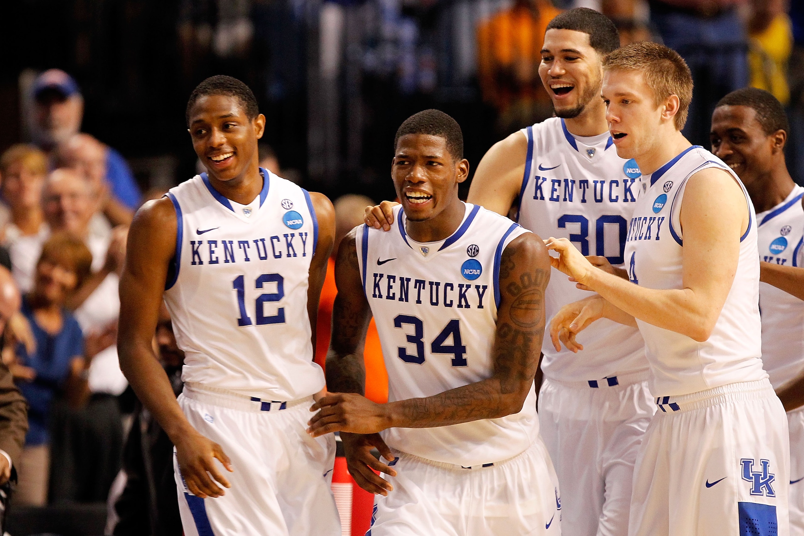 TAMPA, FL - MARCH 19:  (L-R) Brandon Knight #12, DeAndre Liggins #34, Eloy Vargas #30 and Jon Hood #4 of the Kentucky Wildcats celebrate after they won 71-63 against the West Virginia Mountaineers during the third round of the 2011 NCAA men's basketball t