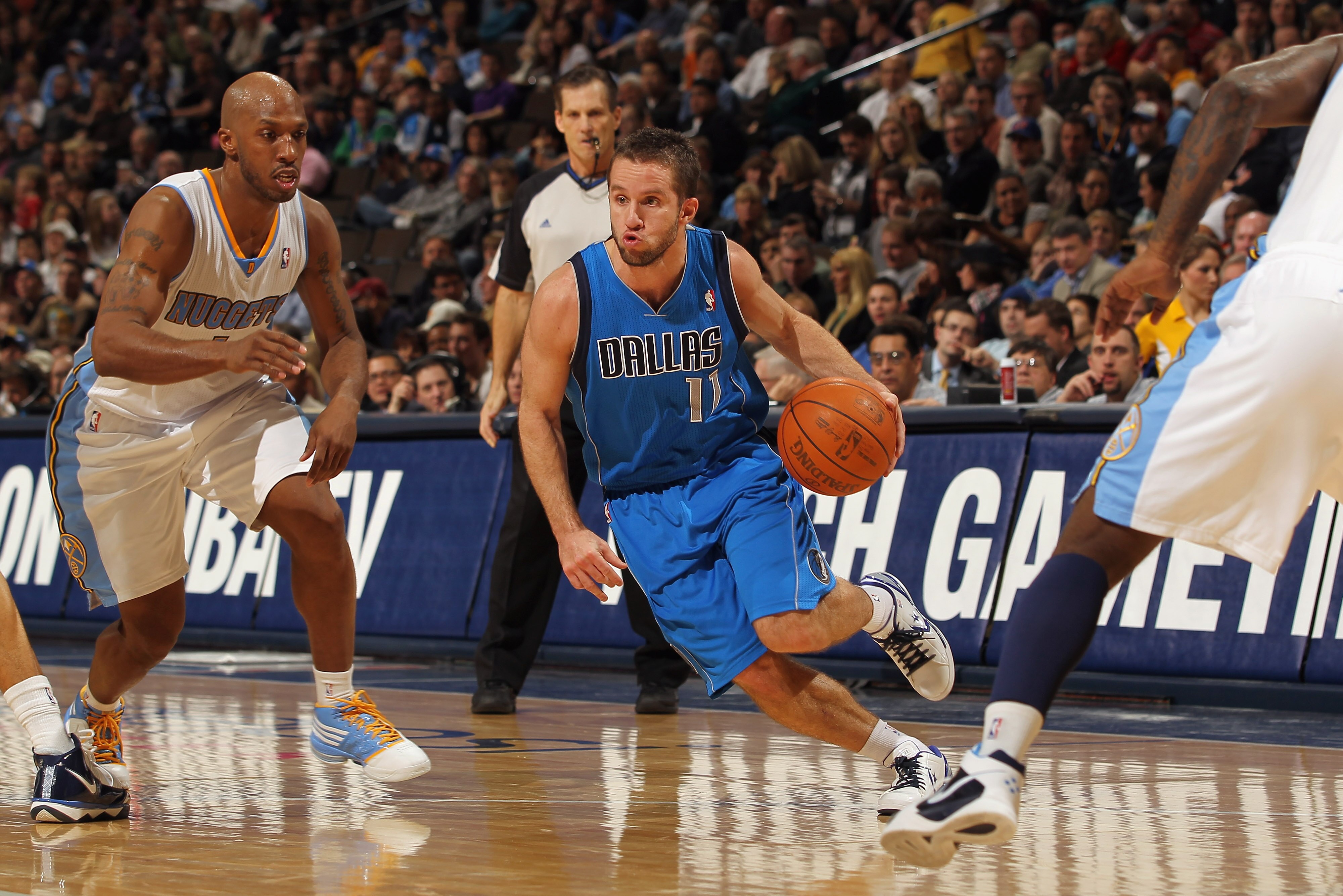 DENVER, CO - FEBRUARY 10:  Jose Barea #11 of the Dallas Mavericks drives the ball against Chauncey Billups #1 of the Denver Nuggets during NBA action at the Pepsi Center on February 10, 2011 in Denver, Colorado. NOTE TO USER: User expressly acknowledges a