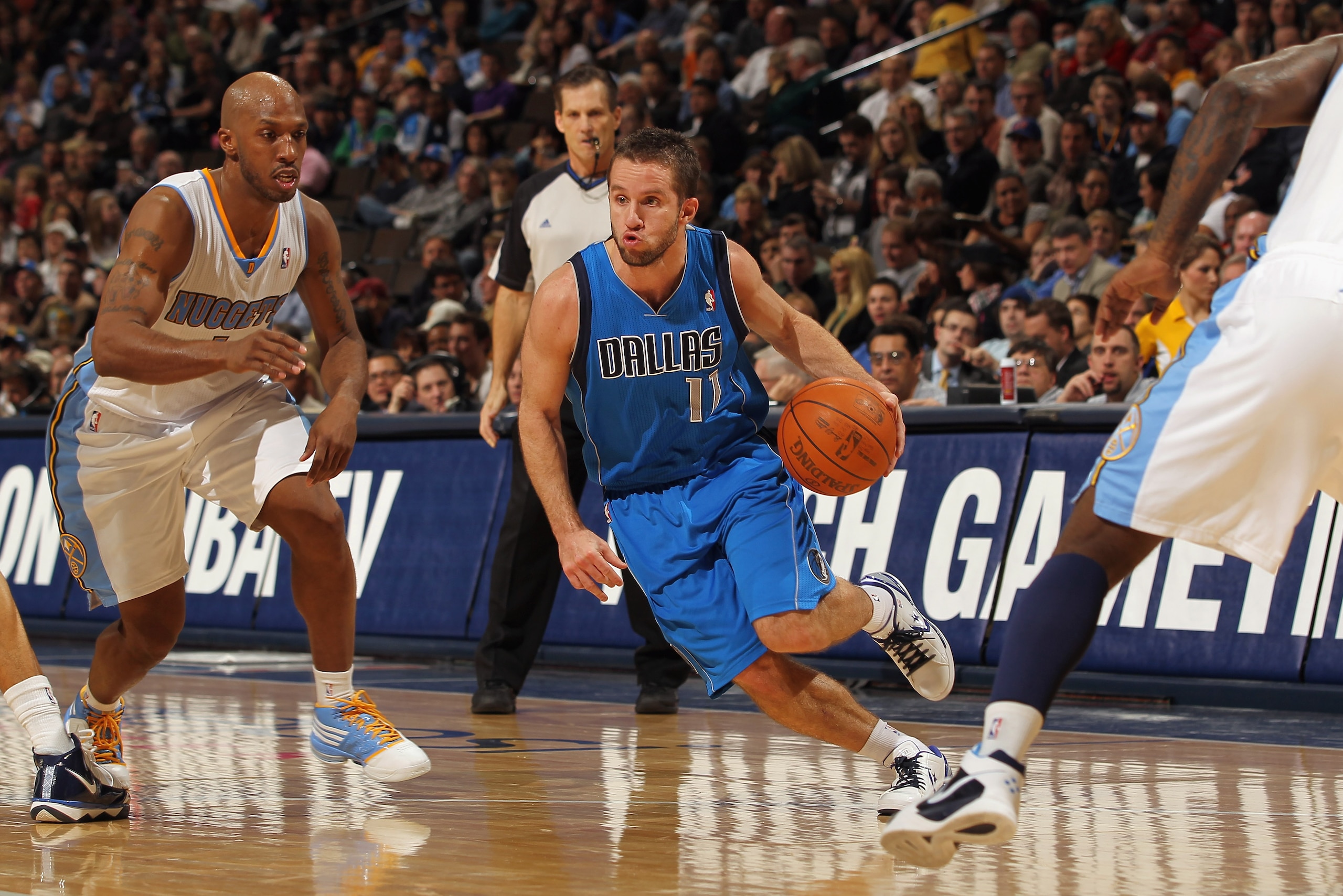 DENVER, CO - FEBRUARY 10:  Jose Barea #11 of the Dallas Mavericks drives the ball against Chauncey Billups #1 of the Denver Nuggets during NBA action at the Pepsi Center on February 10, 2011 in Denver, Colorado. NOTE TO USER: User expressly acknowledges a