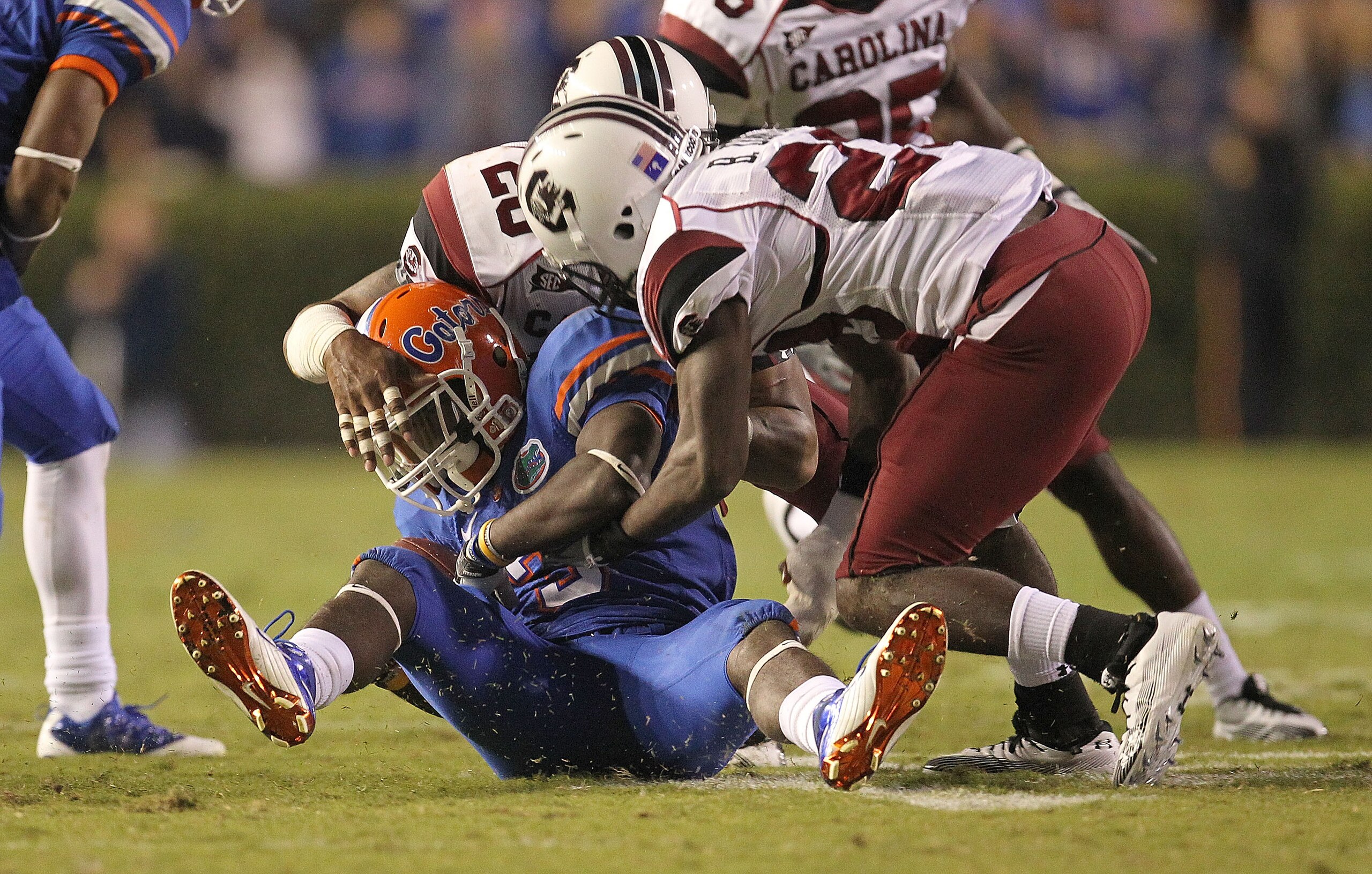 GAINESVILLE, FL - NOVEMBER 13:  Chris Rainey #3 of the Florida Gators is tackled  after a catch against Antonio Allen #26 during a game against the South Carolina Gamecocks at Ben Hill Griffin Stadium on November 13, 2010 in Gainesville, Florida.  (Photo