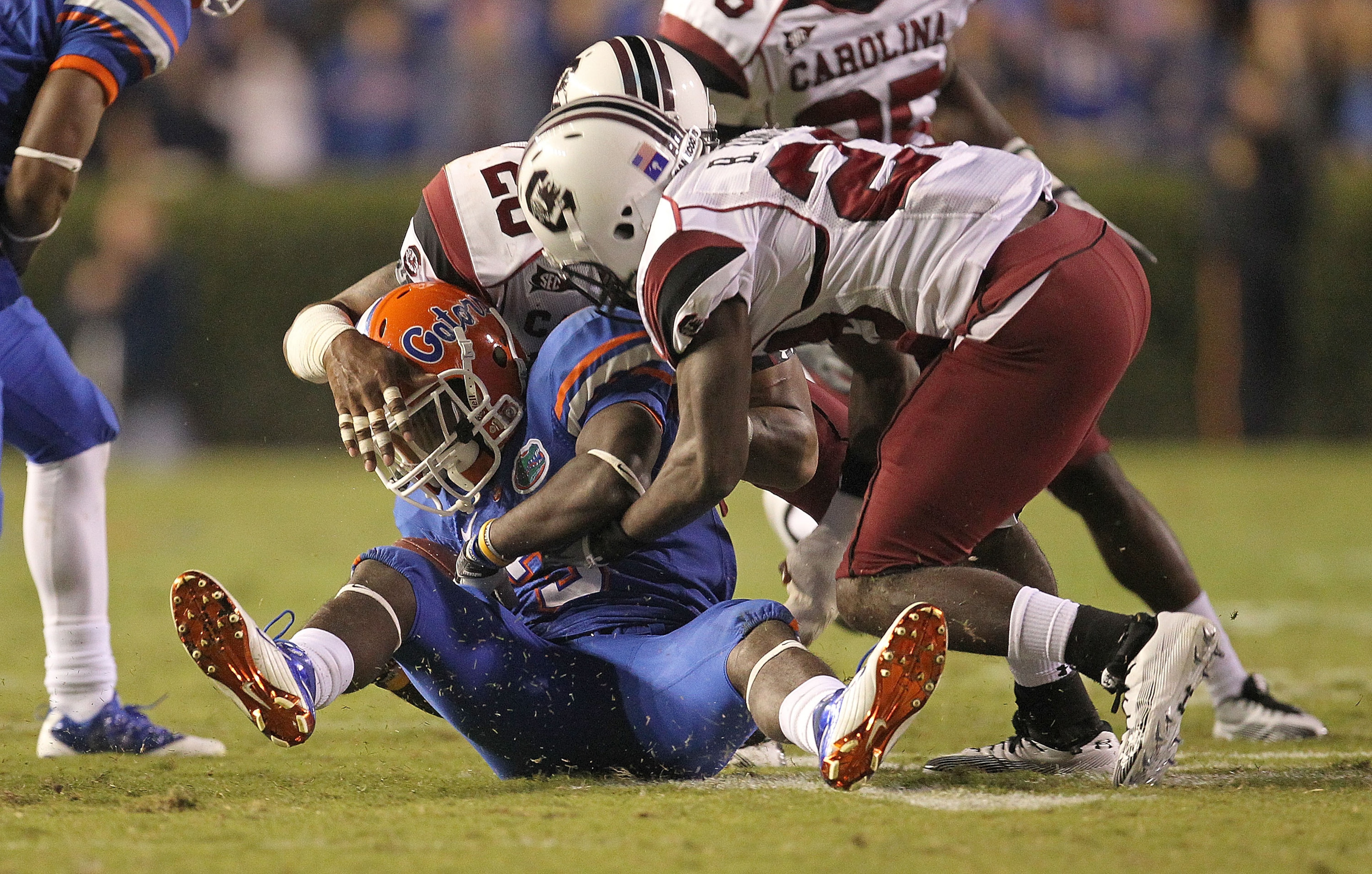 GAINESVILLE, FL - NOVEMBER 13:  Chris Rainey #3 of the Florida Gators is tackled  after a catch against Antonio Allen #26 during a game against the South Carolina Gamecocks at Ben Hill Griffin Stadium on November 13, 2010 in Gainesville, Florida.  (Photo