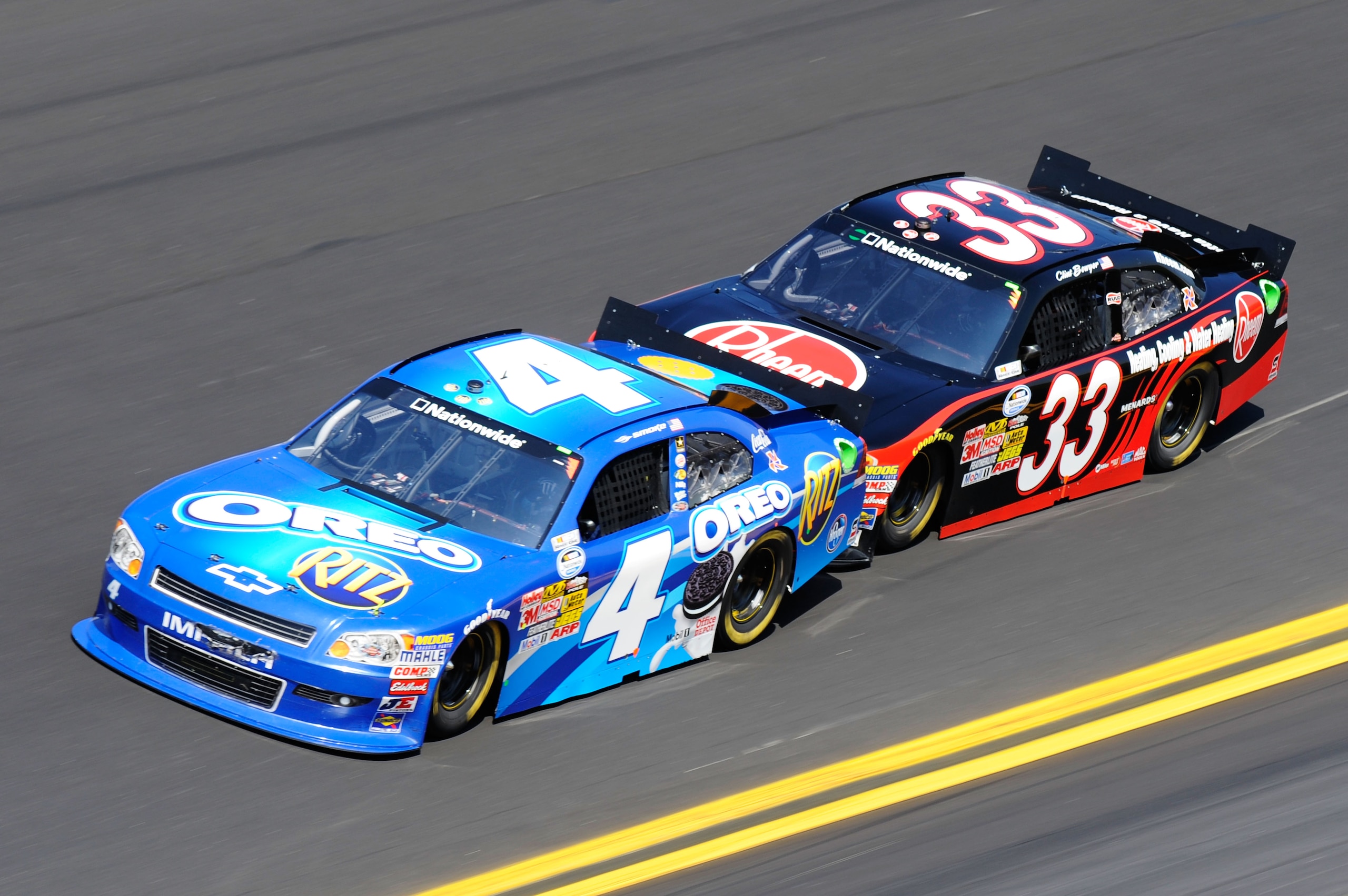 DAYTONA BEACH, FL - FEBRUARY 19:  Tony Stewart, driver of the #4 Oreo/Ritz Chevrolet,  and Clint Bowyer, driver of the #33 Rheem Heating, Cooling & Water Heating Chevrolet, race during the NASCAR Nationwide Series DRIVE4COPD 300 at Daytona International S