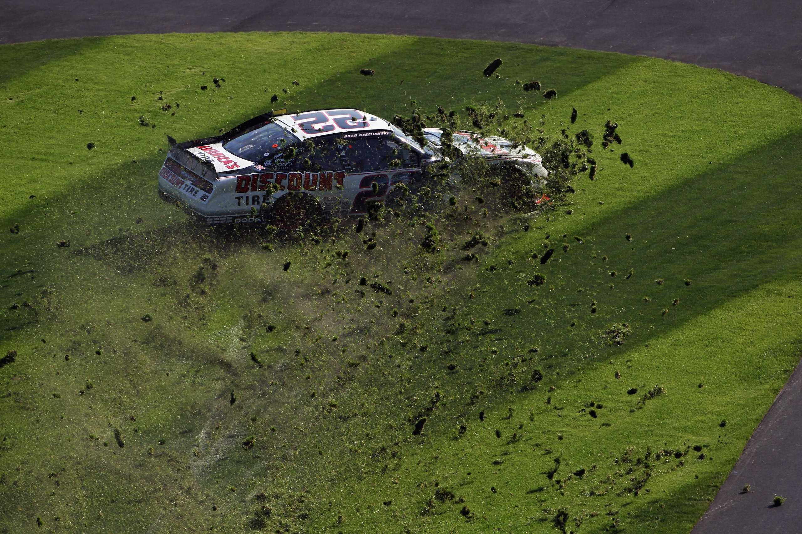 DAYTONA BEACH, FL - FEBRUARY 19:  Brad Keselowski #22 spins through the infield grass during the NASCAR Nationwide Series DRIVE4COPD 300 at Daytona International Speedway on February 19, 2011 in Daytona Beach, Florida.  (Photo by Jamie Squire/Getty Images