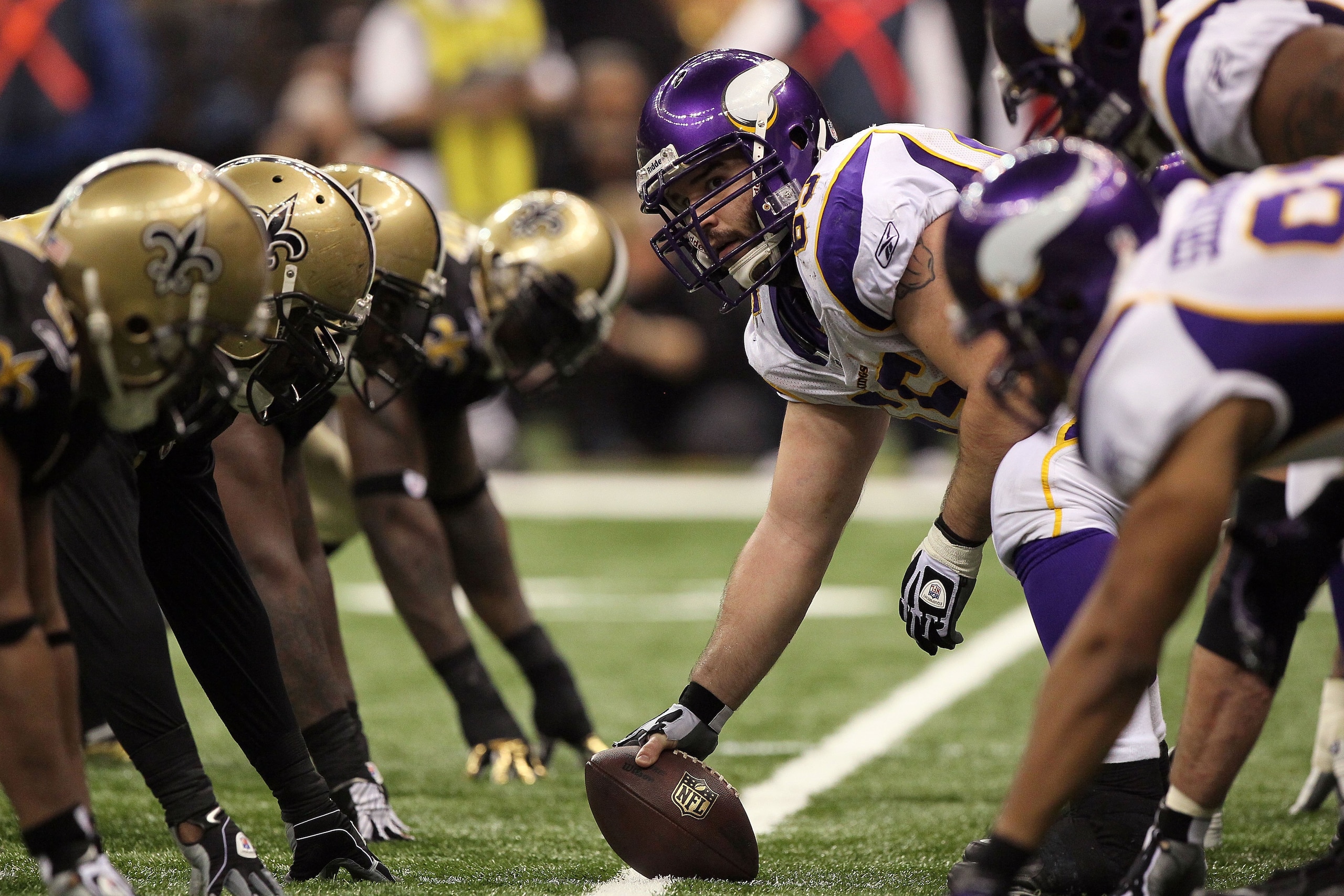 NEW ORLEANS - JANUARY 24:  Offensive center John Sullivan #65 of the Minnesota Vikings looks down the line of scrimmage as he gets set to snap the ball against the New Orleans Saints during the NFC Championship Game at the Louisiana Superdome on January 2