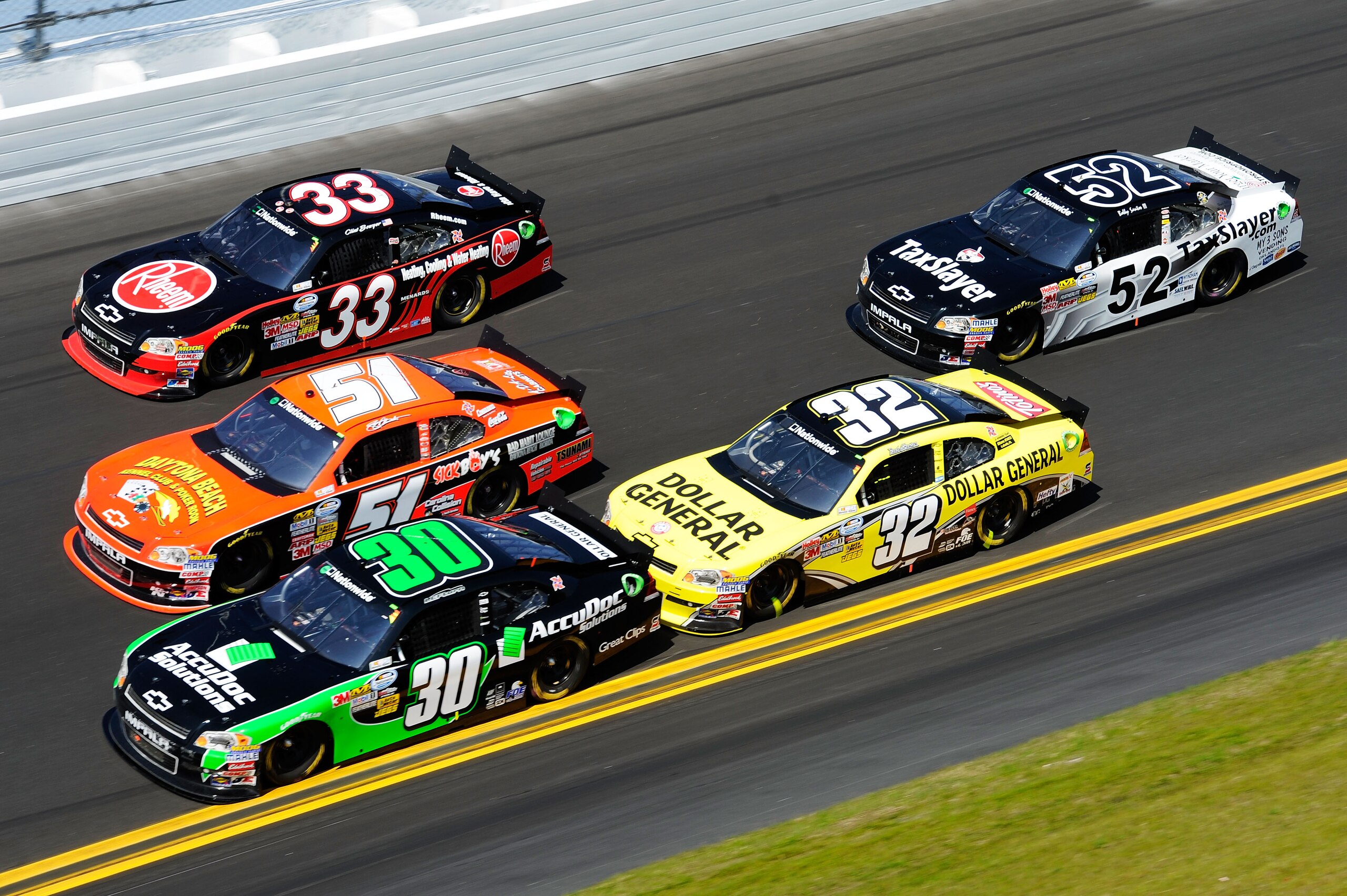 DAYTONA BEACH, FL - FEBRUARY 19:  Jason Leffler, driver of the #30 AccuDoc Chevrolet, Jeremy Clements, driver of the #51 RaceDaySponsor.com Chevrolet, and Clint Bowyer, driver of the #33 Rheem Heating, Cooling & Water Heating Chevrolet, race three wide du