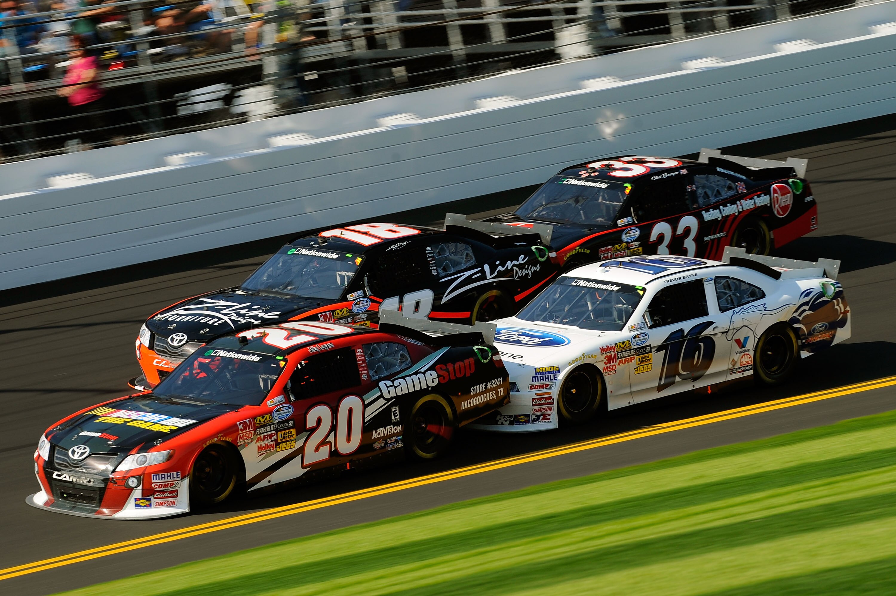 DAYTONA BEACH, FL - FEBRUARY 19:  Joey Logano, driver of the #20 GameStop Toyota, Kyle Busch, driver of the #18 Z-Line Designs Toyota, Clint Bowyer, driver of the #33 Rheem Heating, Cooling & Water Heating Chevrolet, and Trevor Bayne, driver of the #16 Dr