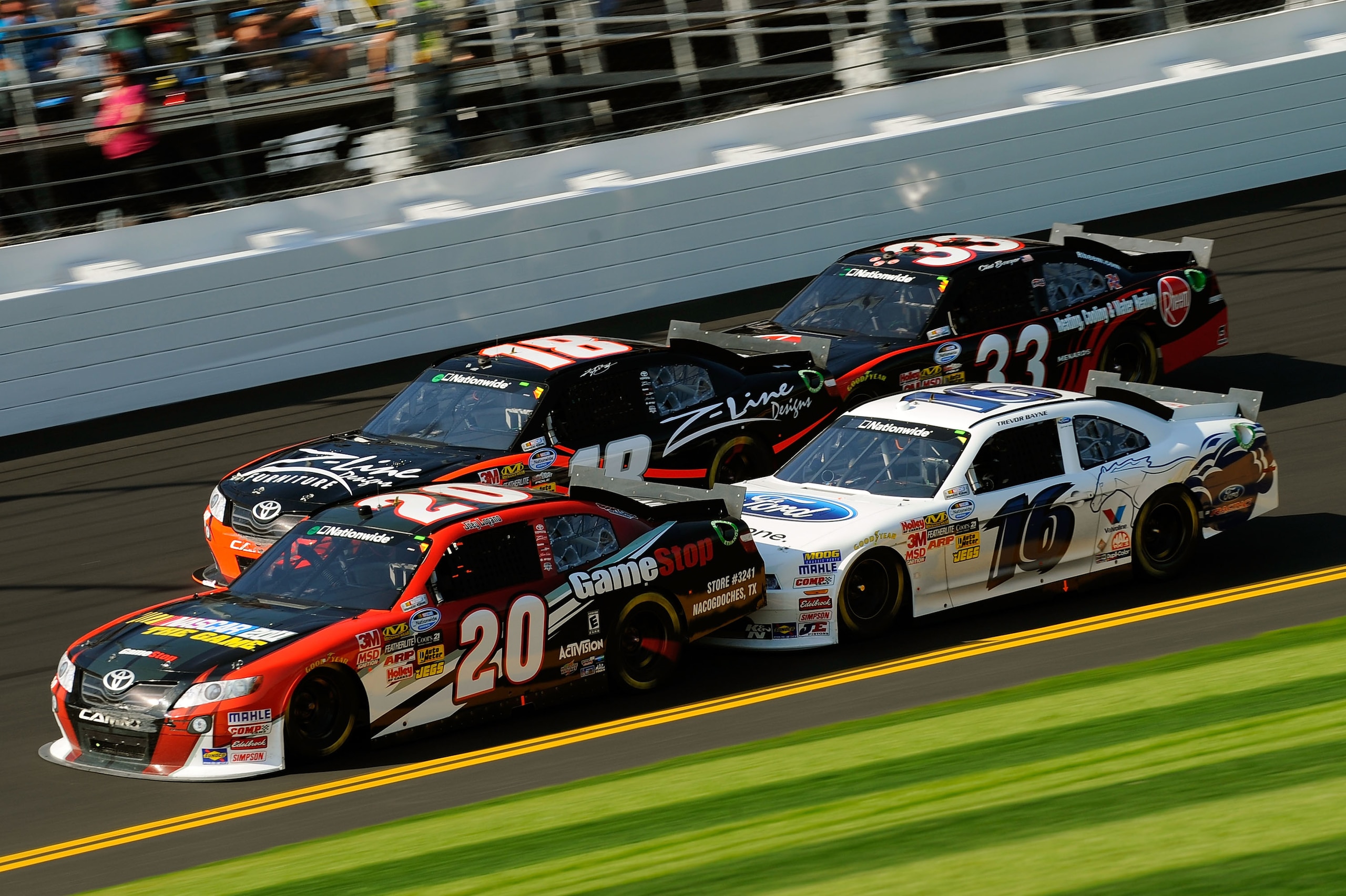 DAYTONA BEACH, FL - FEBRUARY 19:  Joey Logano, driver of the #20 GameStop Toyota, Kyle Busch, driver of the #18 Z-Line Designs Toyota, Clint Bowyer, driver of the #33 Rheem Heating, Cooling & Water Heating Chevrolet, and Trevor Bayne, driver of the #16 Dr