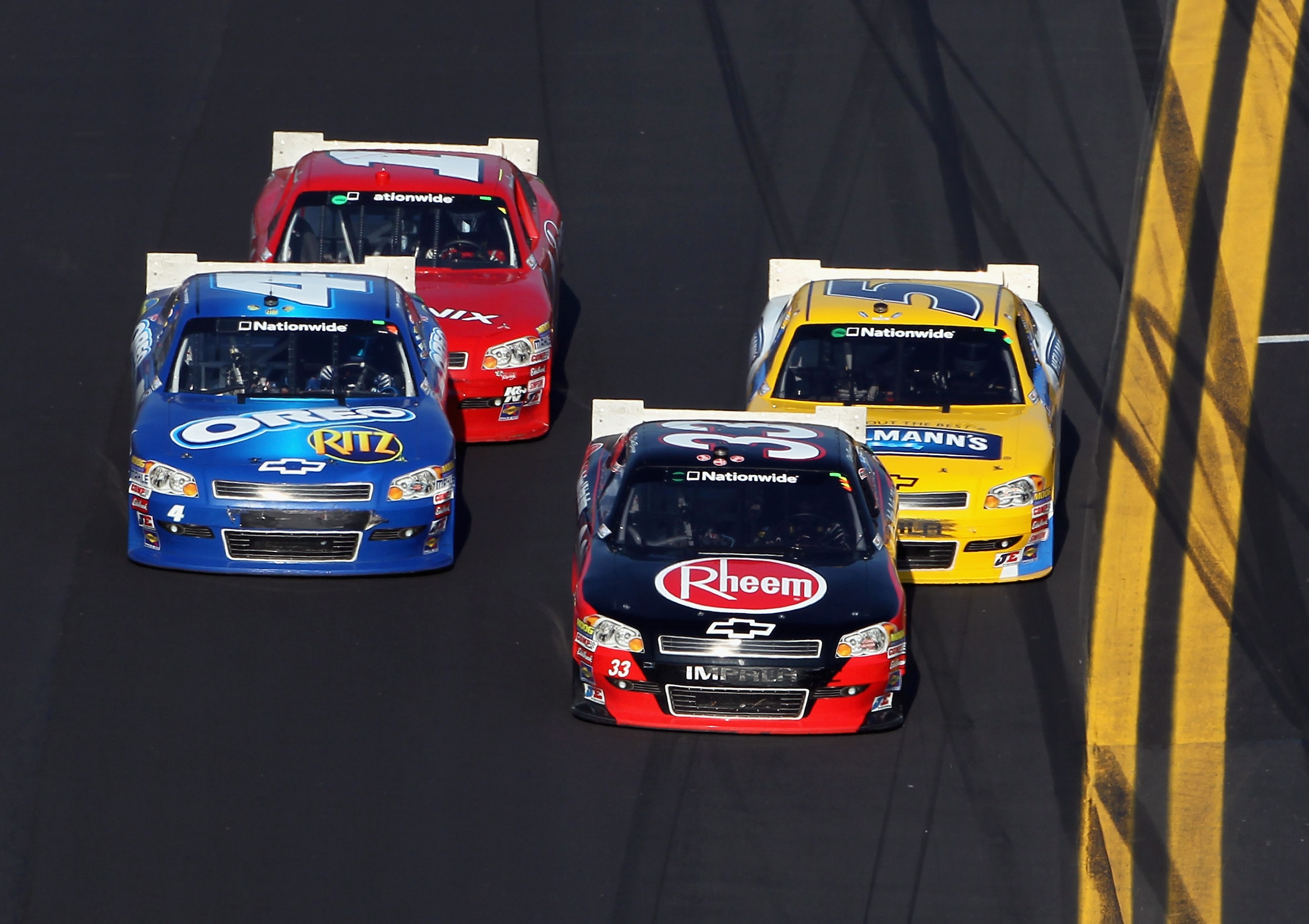 DAYTONA BEACH, FL - FEBRUARY 19:  Tony Stewart #4 passes Clint Bowyer #33 on his way toward winning the NASCAR Nationwide Series DRIVE4COPD 300 at Daytona International Speedway on February 19, 2011 in Daytona Beach, Florida.  (Photo by Jamie Squire/Getty