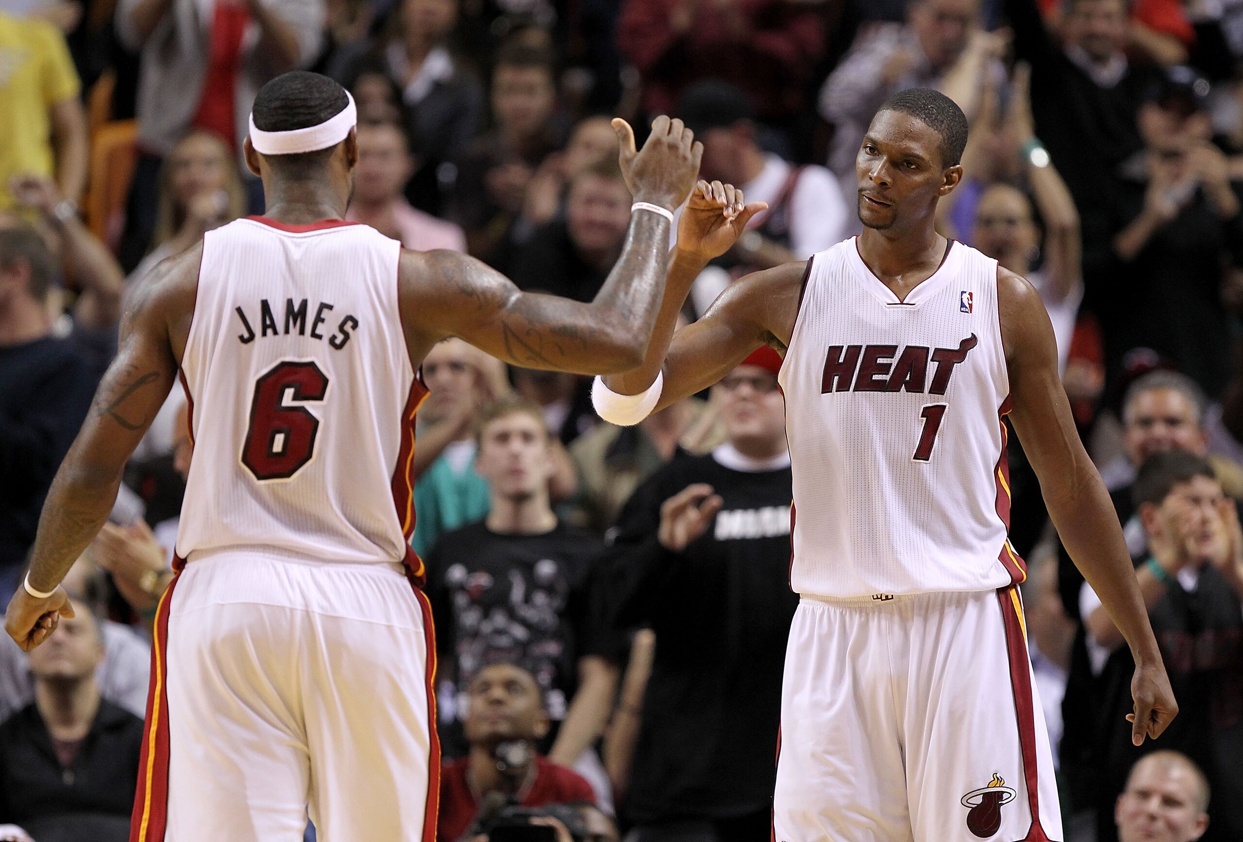 MIAMI, FL - DECEMBER 20: LeBron James #6 and Chris Bosh #1 of the Miami Heat high five during a game against the Dallas Mavericks at American Airlines Arena on December 20, 2010 in Miami, Florida. NOTE TO USER: User expressly acknowledges and agrees that,