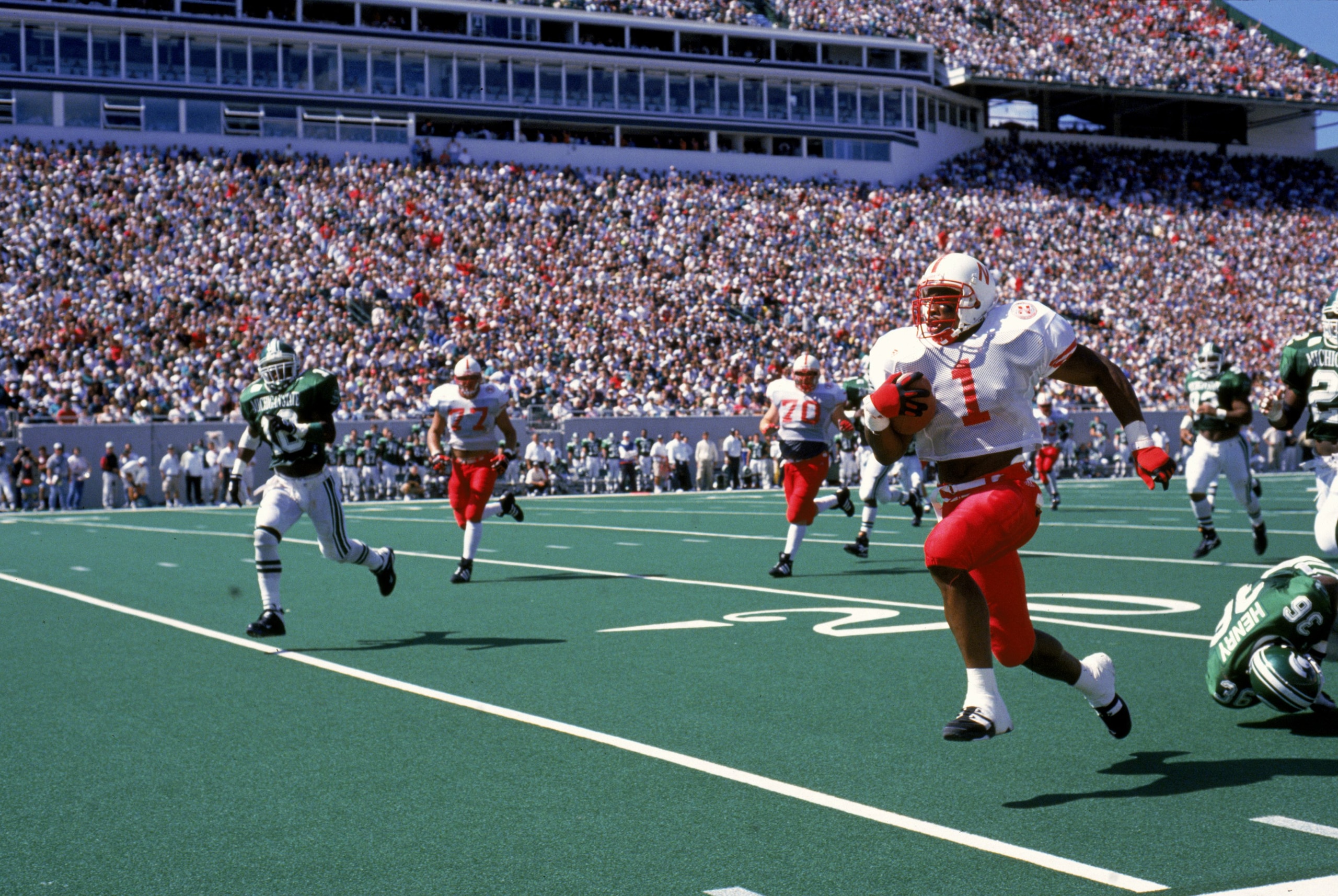 9 Nov 1995: Lawrence Phillips #1 of the Nebraska Cornhuskers carries the ball during a game against the Michigan State Spartans at the Spartan Stadium in East Lansing, Michigan. The Cornhuskers defeated the Spartans 50-10. Mandatory Credit: Jonathan Danie 9 Nov 1995: Lawrence Phillips #1 of the Nebraska Cornhuskers carries the ball during a game against the Michigan State Spartans at the Spartan Stadium in East Lansing, Michigan. The Cornhuskers defeated the Spartans 50-10. Mandatory Credit: Jonathan Danie