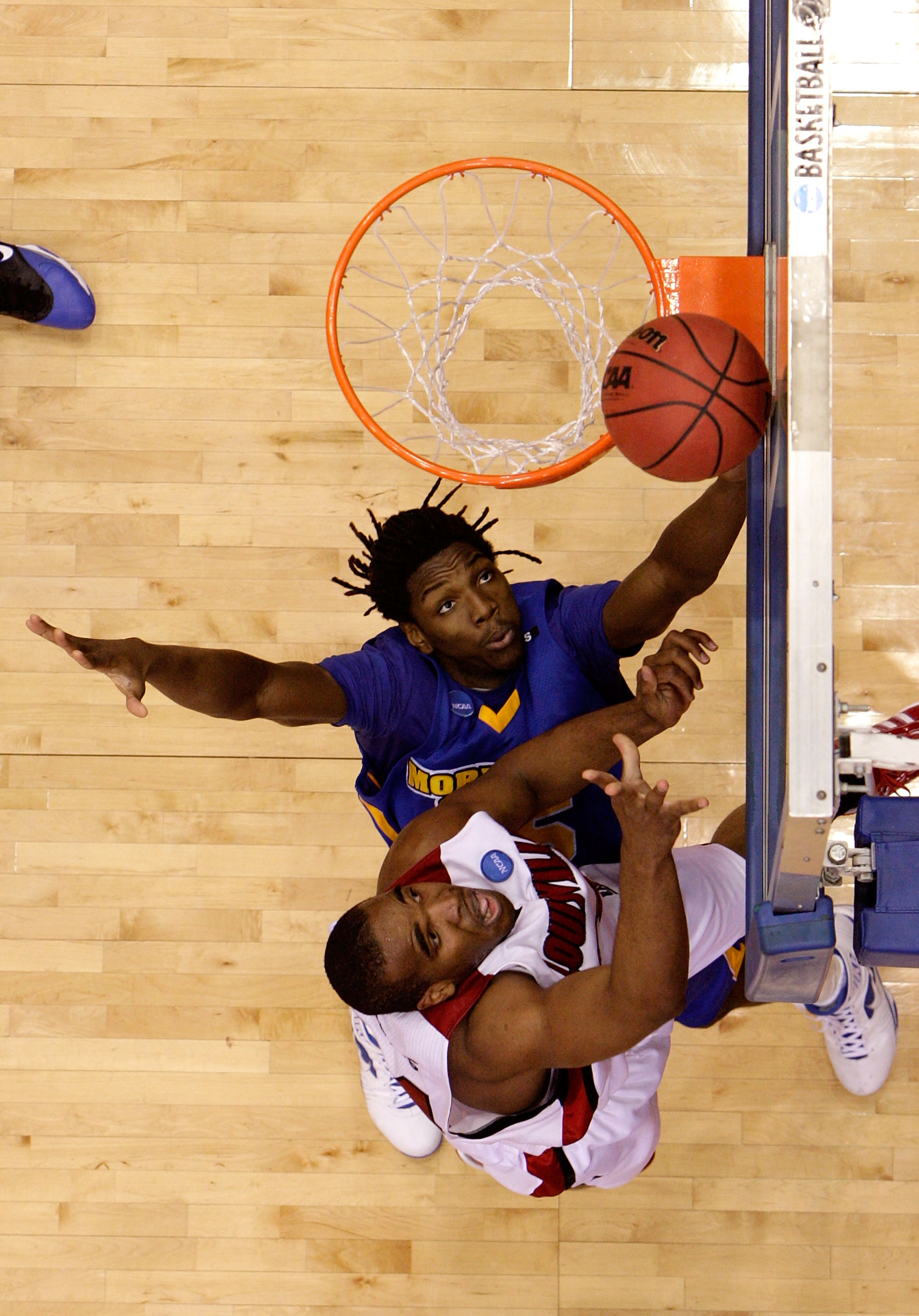 DAYTON, OH - MARCH 20: Samardo Samuels #24 of the Louisville Cardinals drives to the hoop against Kenneth Faried #35 of the Morehead State Eagles during the first round of the NCAA Division I Men's Basketball Tournament at the University of Dayton Arena o
