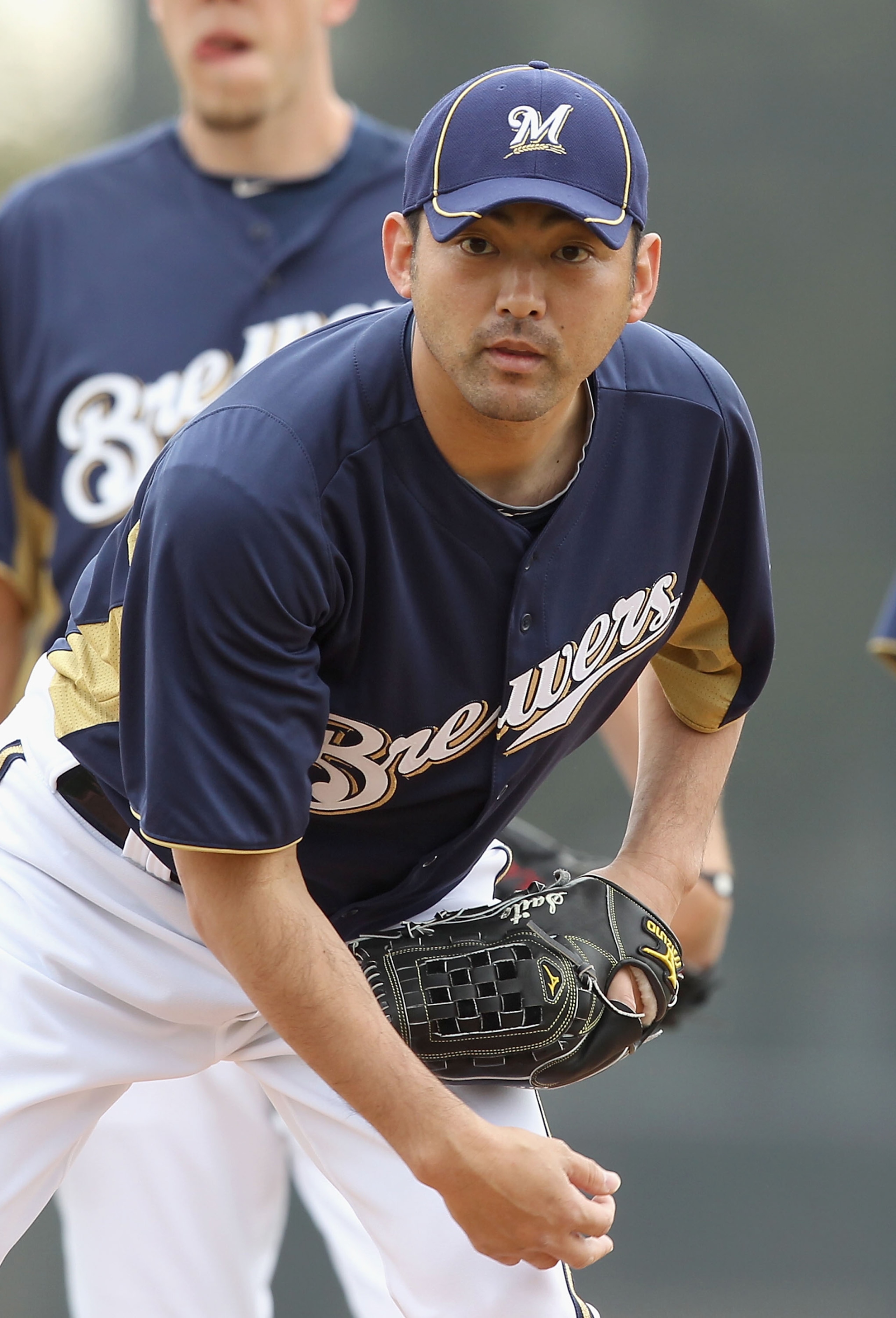 PHOENIX, AZ - FEBRUARY 18:  Pitcher Takashi Saito #40 of the Milwaukee Brewers participates in fielding drills during a MLB spring training practice at Maryvale Baseball Park on February 18, 2011 in Phoenix, Arizona.  (Photo by Christian Petersen/Getty Im