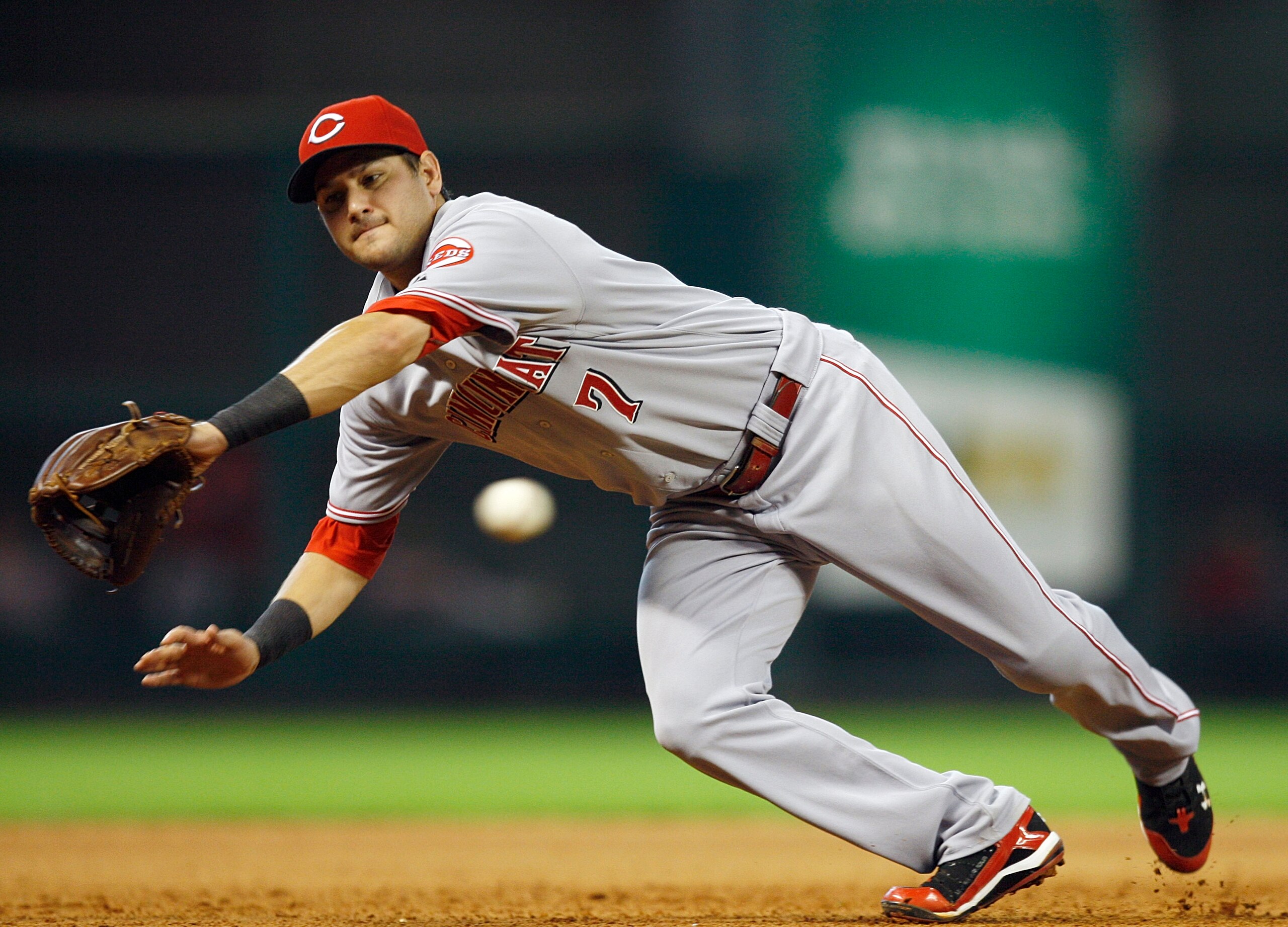 HOUSTON - JULY 24:  Third baseman Paul Janish #7 of the Cincinnati Reds comes up short on ball hit down the line against the Houston Astros at Minute Maid Park on July 24, 2010 in Houston, Texas.  (Photo by Bob Levey/Getty Images)