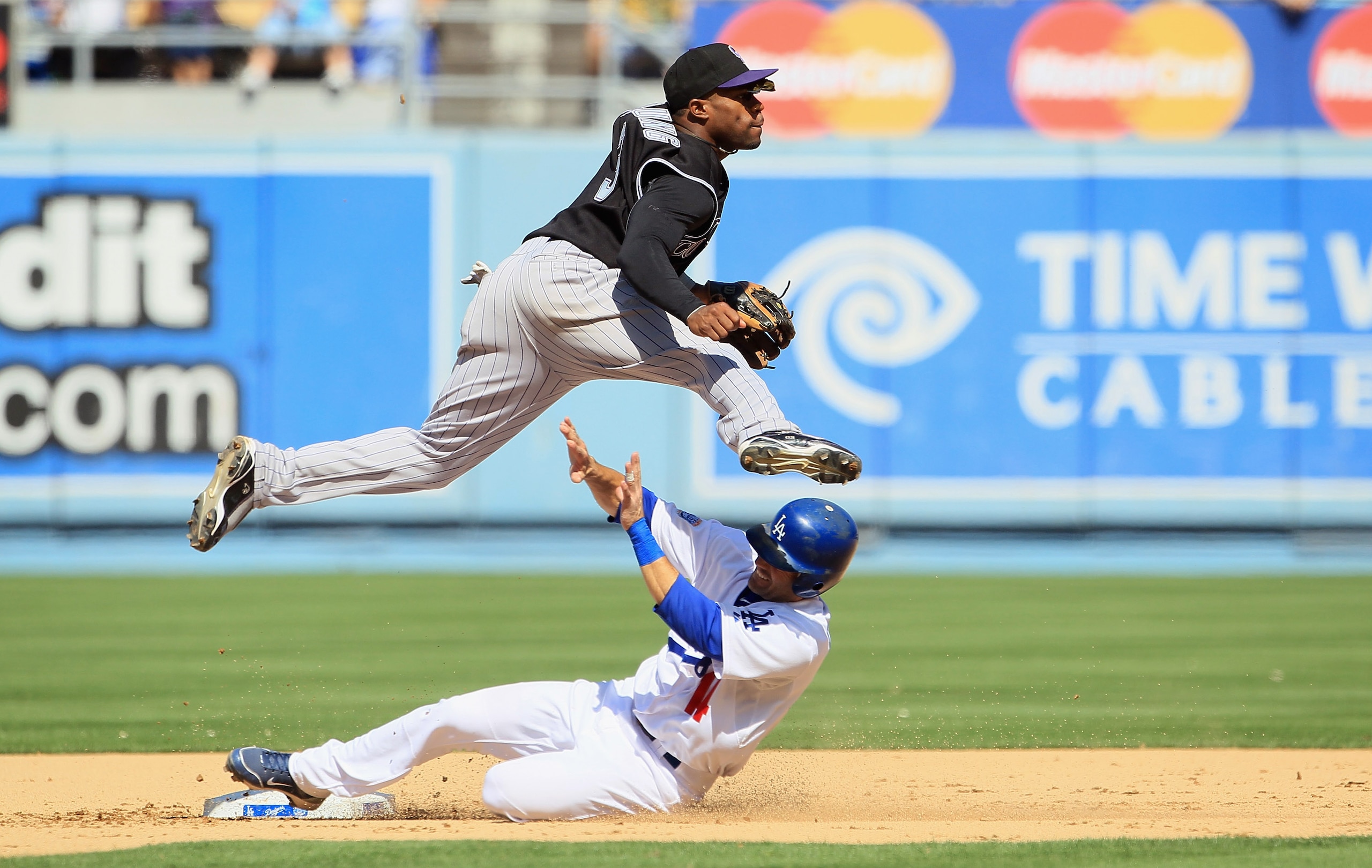 LOS ANGELES, CA - SEPTEMBER 18:  Second baseman Eric Young #3 of the Colorado Rockies jumps to avoid Jamey Carroll #14 of the Los Angeles Dodgers after forcing him out at second base in the fifth inning at Dodger Stadium on September 18, 2010 in Los Angel