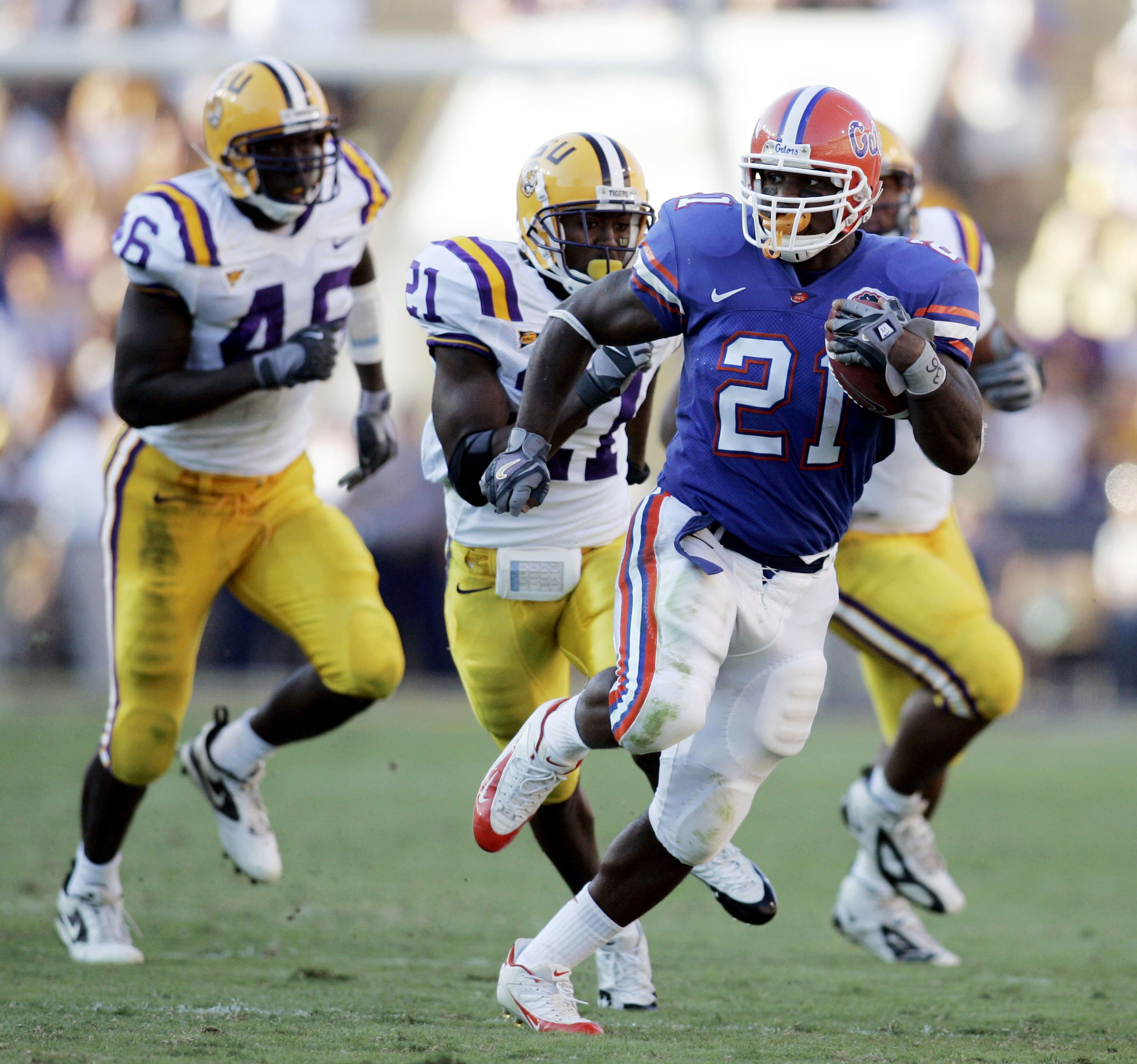 BATON ROUGE, LA - OCTOBER 15:  DeShawn Wynn #21 of the University of Florida is chased by members of the Louisiana State University defense at Tiger Stadium in Baton Rouge, Louisiana on October 15, 2005. LSU defeated the University of Florida 21-17.  (Pho