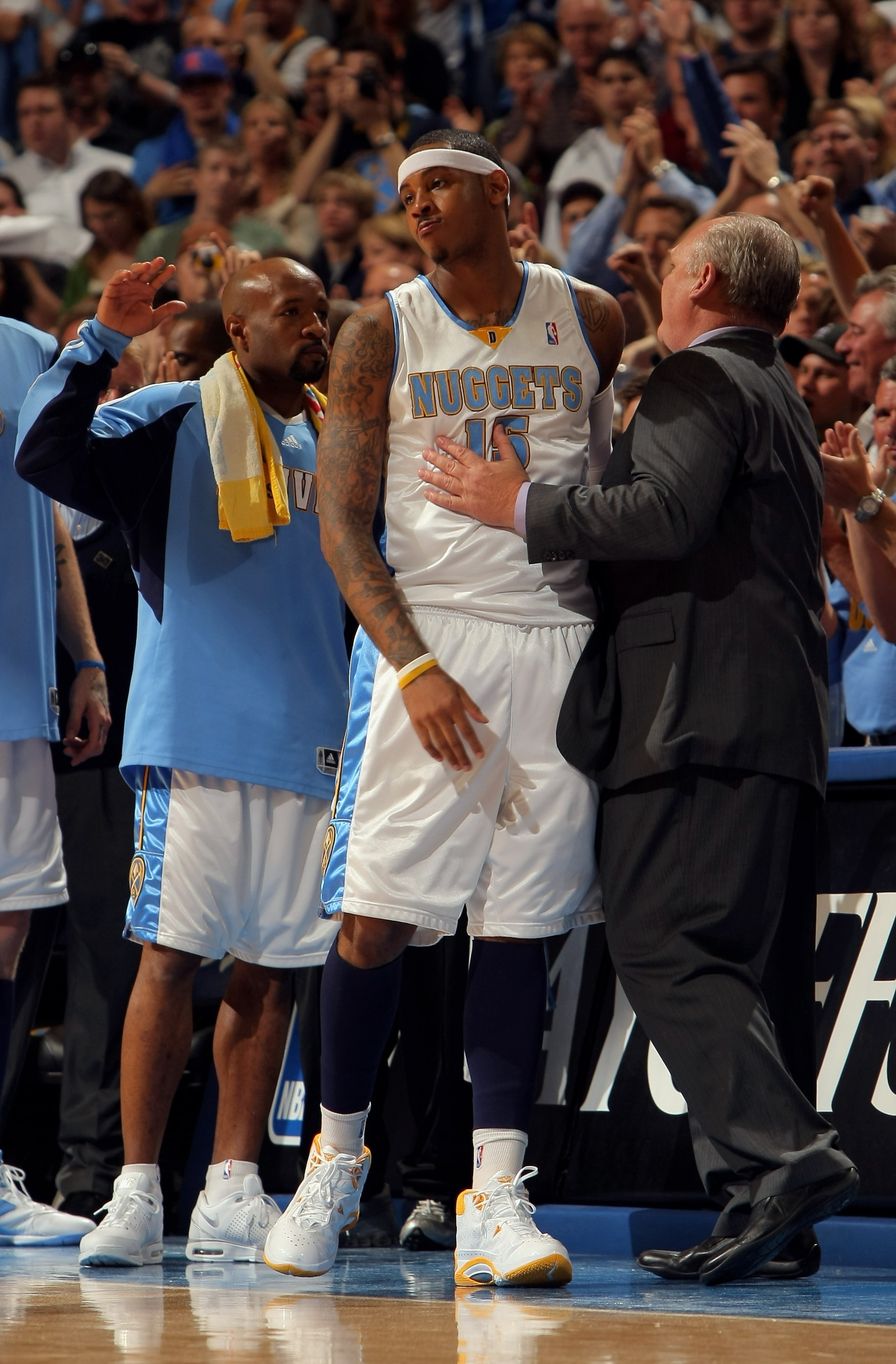 DENVER - MAY 13:  Carmelo Anthony #15 of the Denver Nuggets is welcomed off court by head coach George Karl late in the fourth quarter against the Dallas Mavericks in Game Five of the Western Conference Semifinals during the 2009 NBA Playoffs at Pepsi Cen