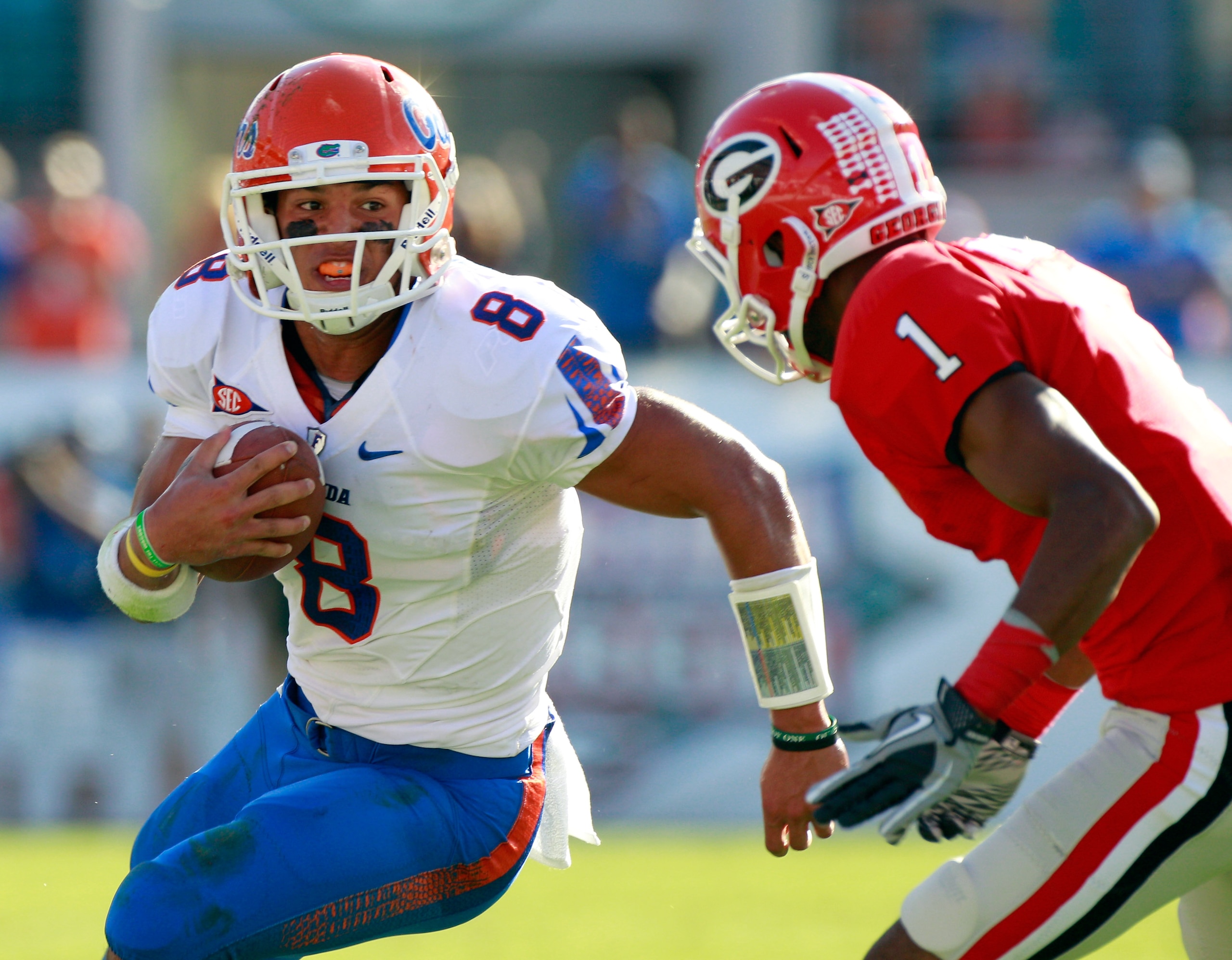 JACKSONVILLE, FL - OCTOBER 30:  Quarterback Trey Burton #8 of the Florida Gators attempts to run past Branden Smith #1 of the Georgia Bulldogs during the game at EverBank Field on October 30, 2010 in Jacksonville, Florida.  (Photo by Sam Greenwood/Getty I