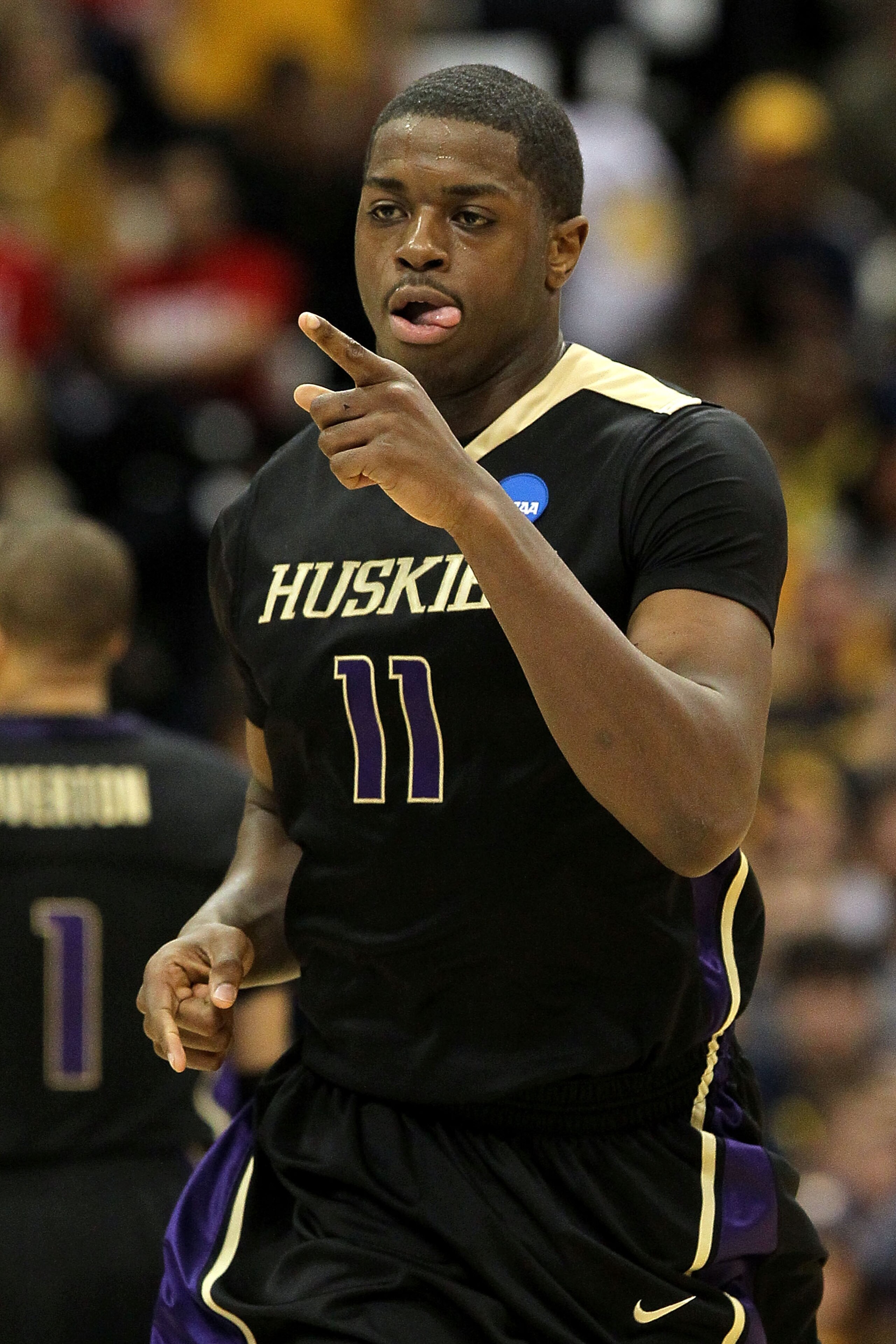 SYRACUSE, NY - MARCH 25:  Matthew Bryan-Amaning #11 of the Washington Huskies reacts in the first half against the West Virginia Mountaineers during the east regional semifinal of the 2010 NCAA men's basketball tournament at the Carrier Dome on March 25,