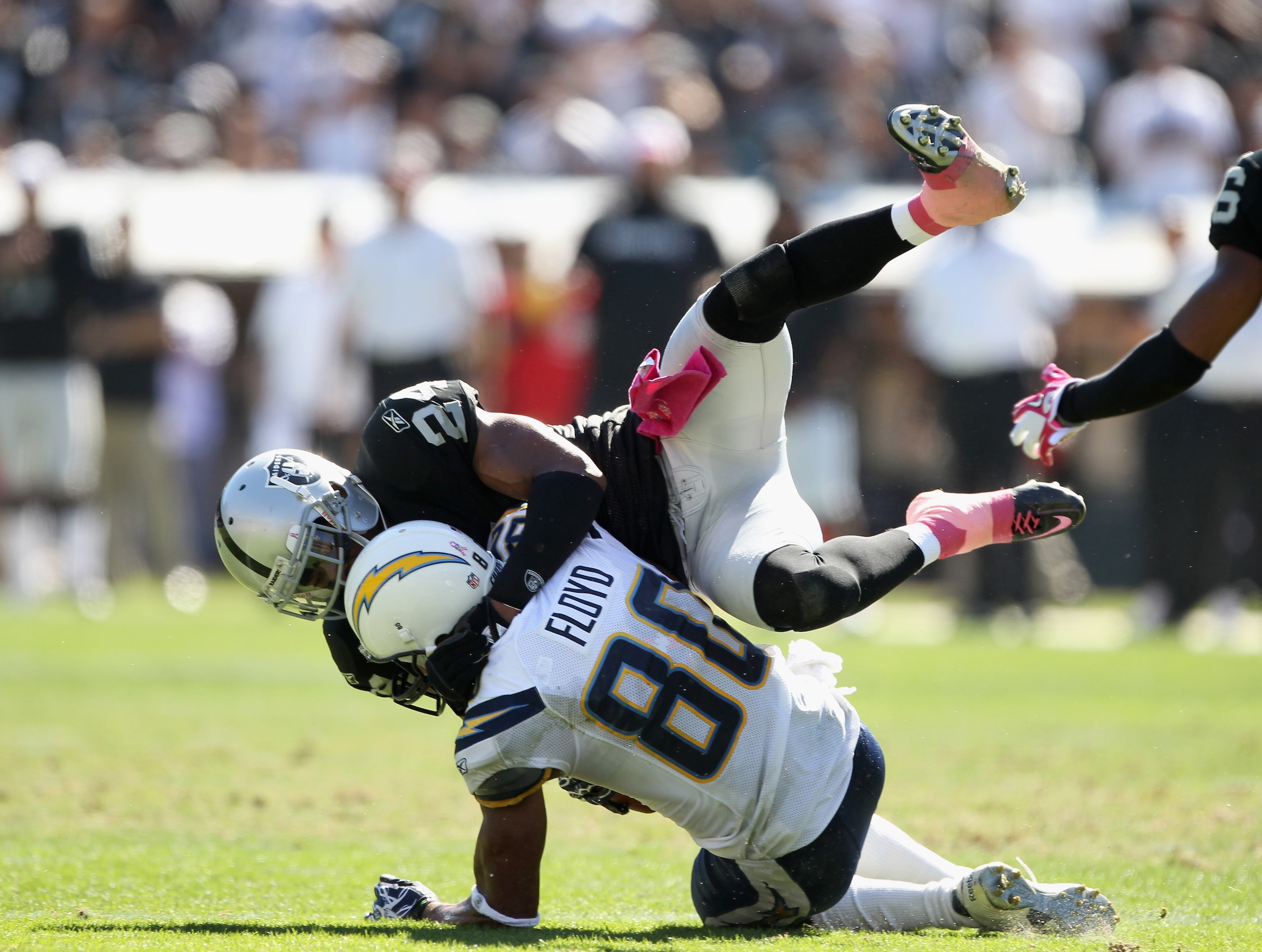 OAKLAND, CA - OCTOBER 10:  Malcom Floyd #80 of the San Diego Chargers is tackled by Michael Huff #24 of the Oakland Raiders at Oakland-Alameda County Coliseum on October 10, 2010 in Oakland, California.  (Photo by Ezra Shaw/Getty Images)
