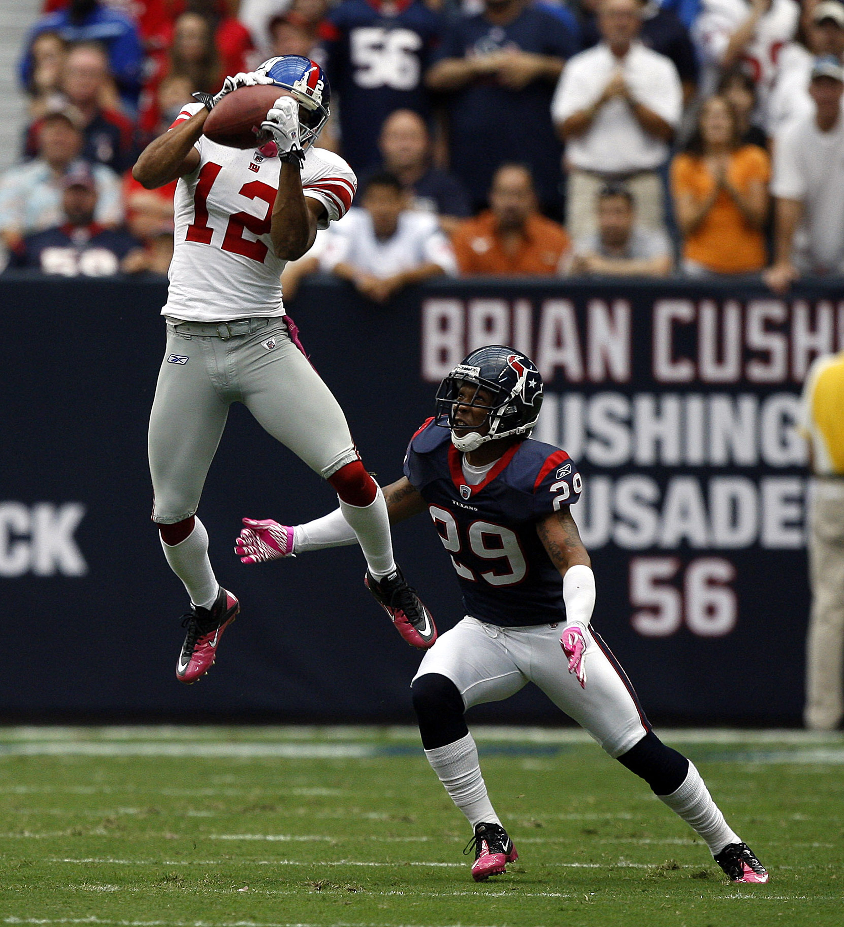 HOUSTON - OCTOBER 10:  Wide receiver Steve Smith #12 of the New York Giants goes up high in front of cornerback Glover Quin #29 of the Houston Texans in the first half at Reliant Stadium on October 10, 2010 in Houston, Texas.  (Photo by Bob Levey/Getty Im