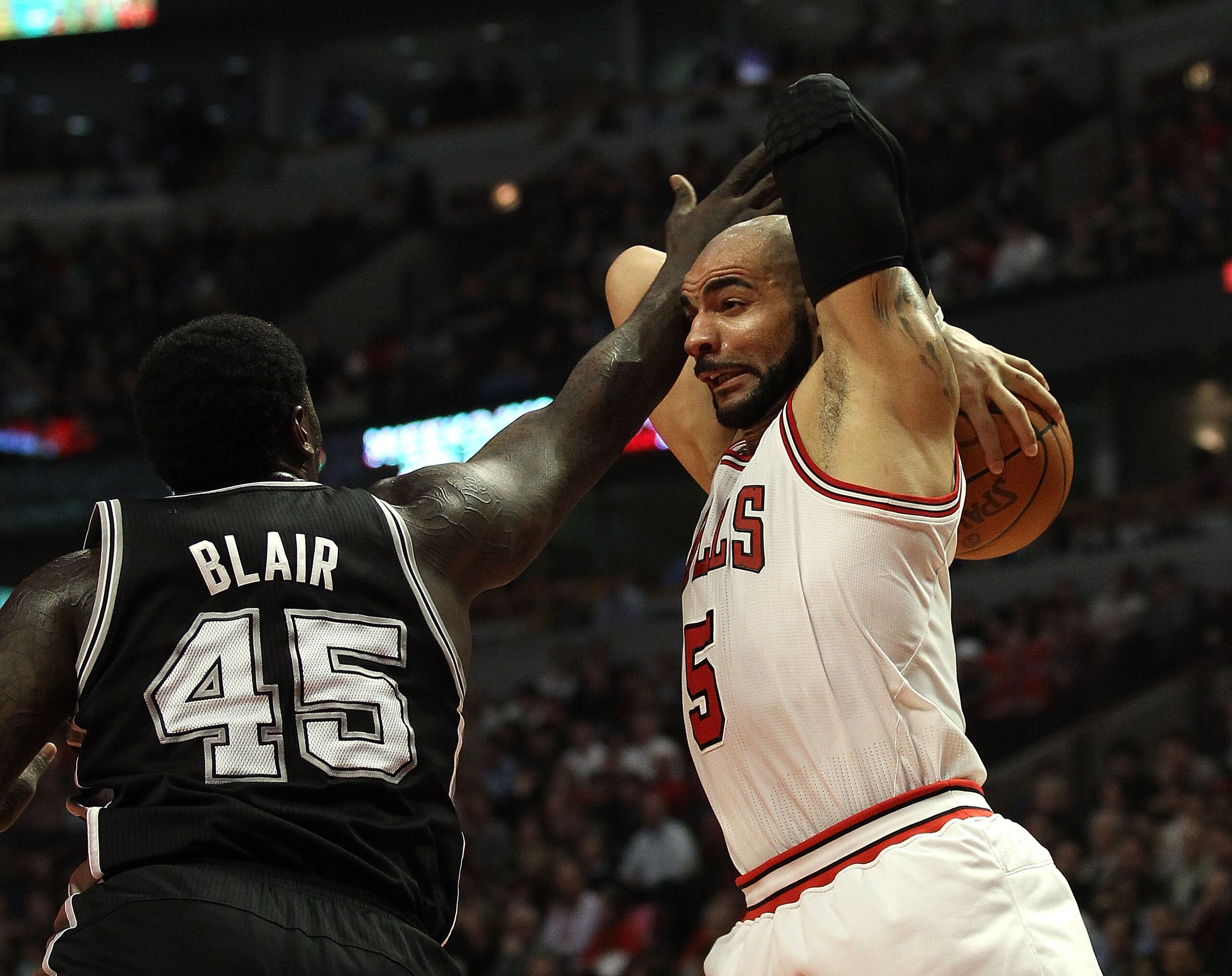 CHICAGO, IL - FEBRUARY 17: Carlos Boozer #5 of the Chicago Bulls grabs a rebound under pressure from DeJuan Blair #45 of the San Antonio Spurs at the United Center on February 17, 2011 in Chicago, Illinois. NOTE TO USER: User expressly acknowledges and ag