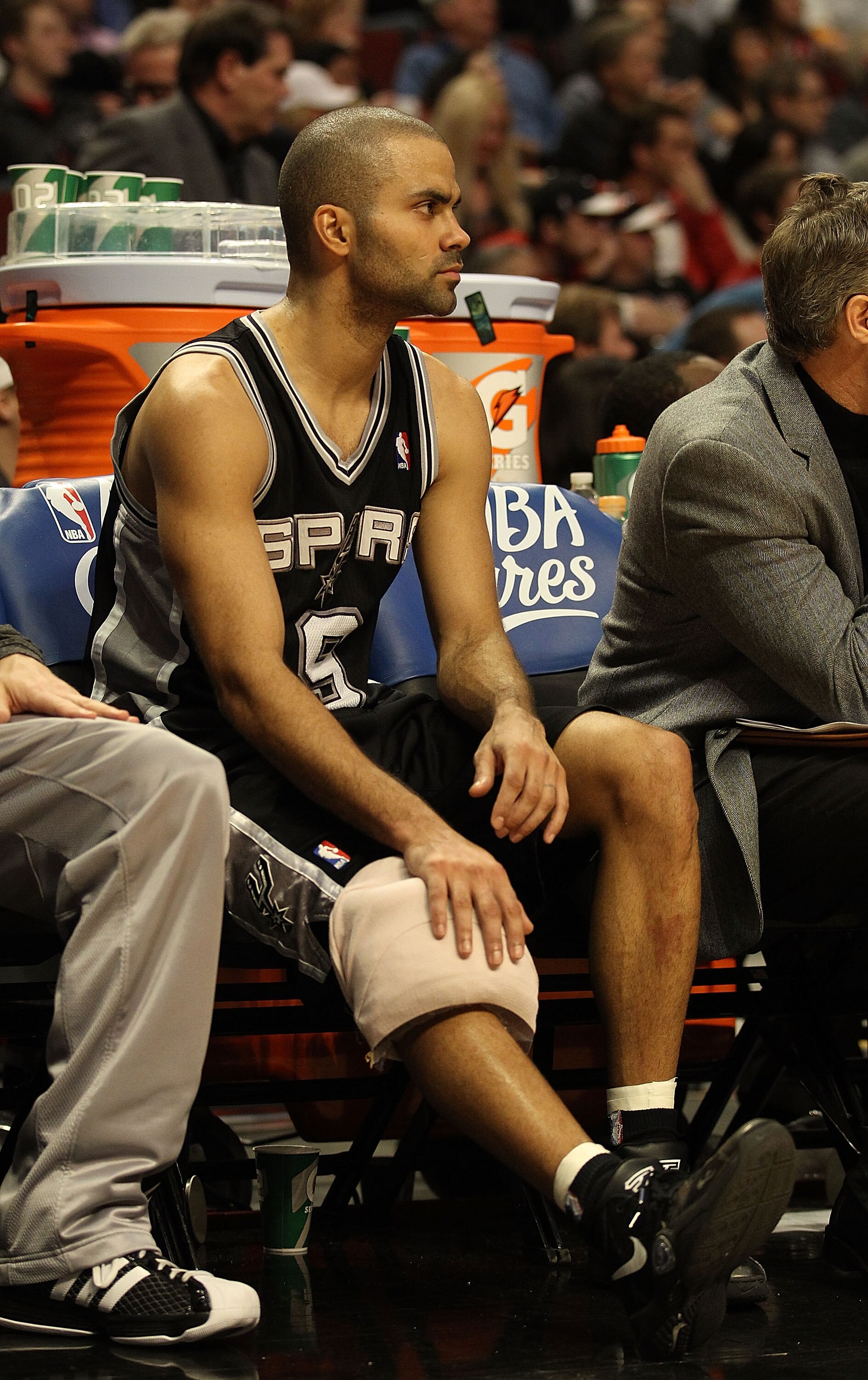 CHICAGO, IL - FEBRUARY 17: Tony Parker #9 of the San Antonio Spurs sits on the bench with a knee injury near the end of a game against the Chicago Bulls at the United Center on February 17, 2011 in Chicago, Illinois. The Bulls defeated the Spurs 109-99. N