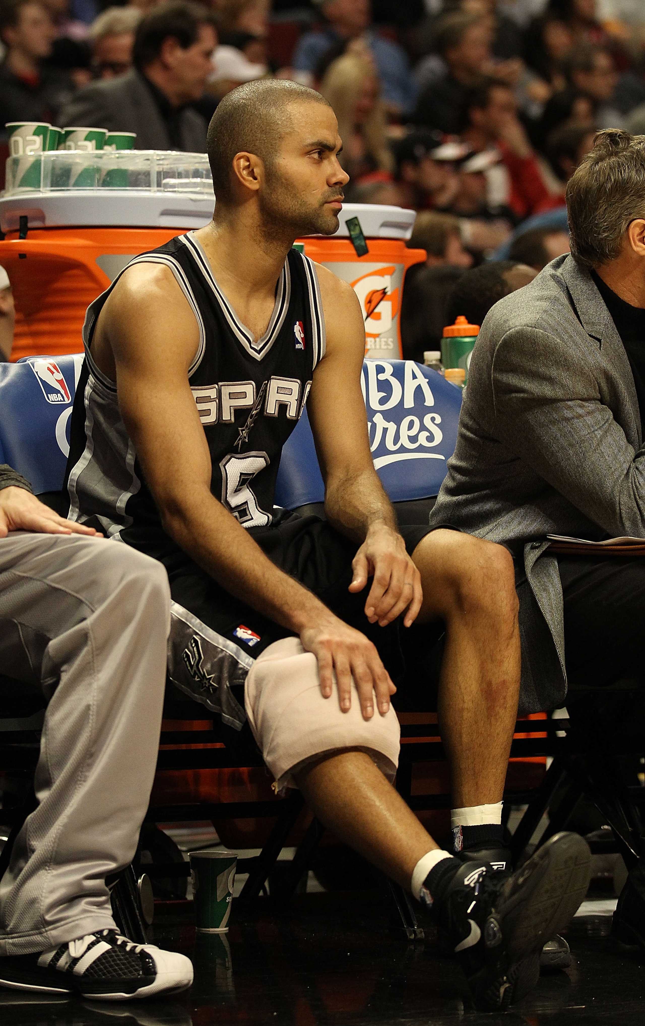 CHICAGO, IL - FEBRUARY 17: Tony Parker #9 of the San Antonio Spurs sits on the bench with a knee injury near the end of a game against the Chicago Bulls at the United Center on February 17, 2011 in Chicago, Illinois. The Bulls defeated the Spurs 109-99. N