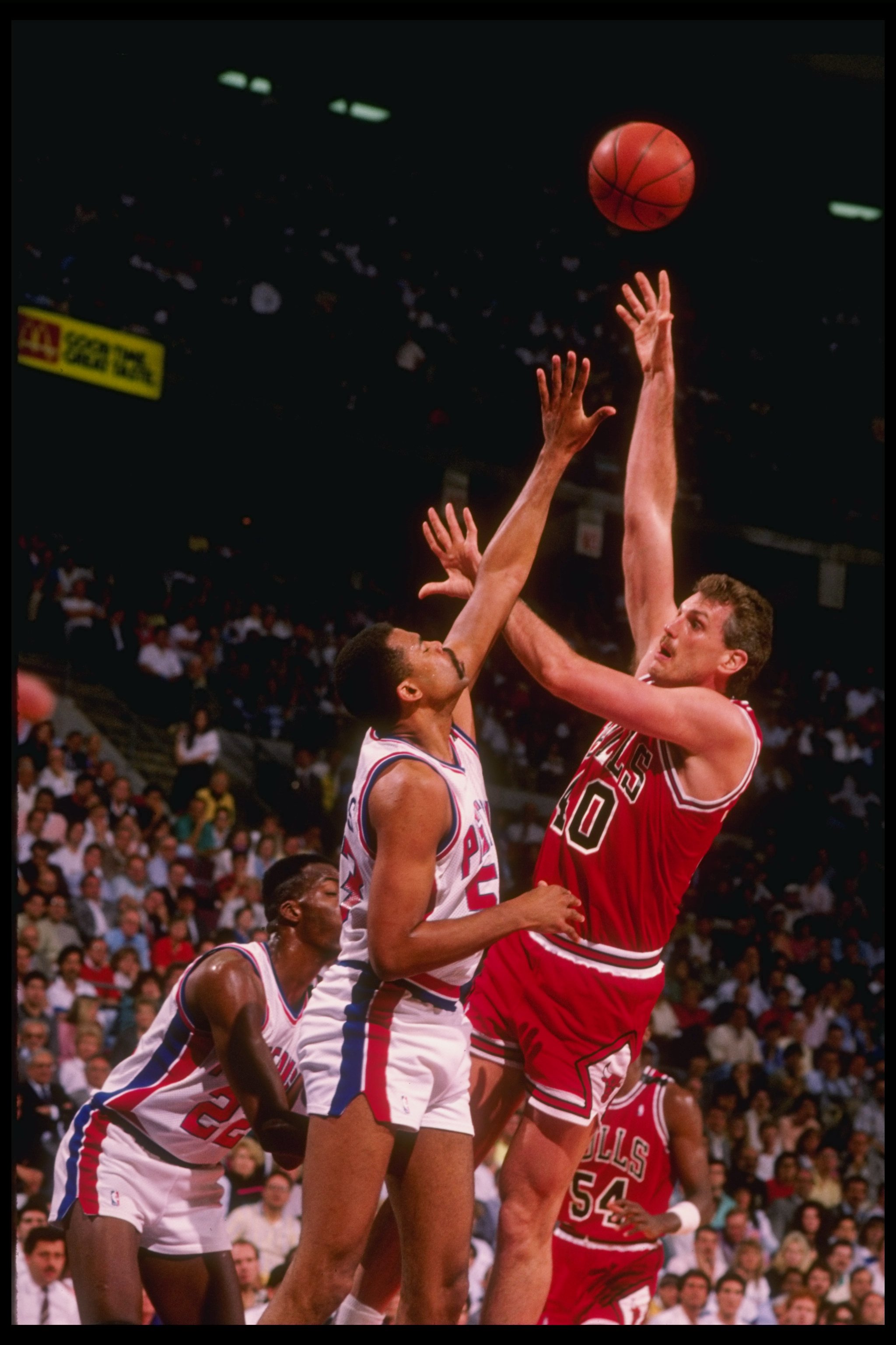 1989:  Dave Corzine of the Chicago Bulls (right) tries to get the ball away from center James Edwards of the Detroit Pistons (center) during an NBA playoff game at the Palace of Auburn Hills in Auburn Hill, Michigan. Mandatory Credit: Allsport  /Allsport