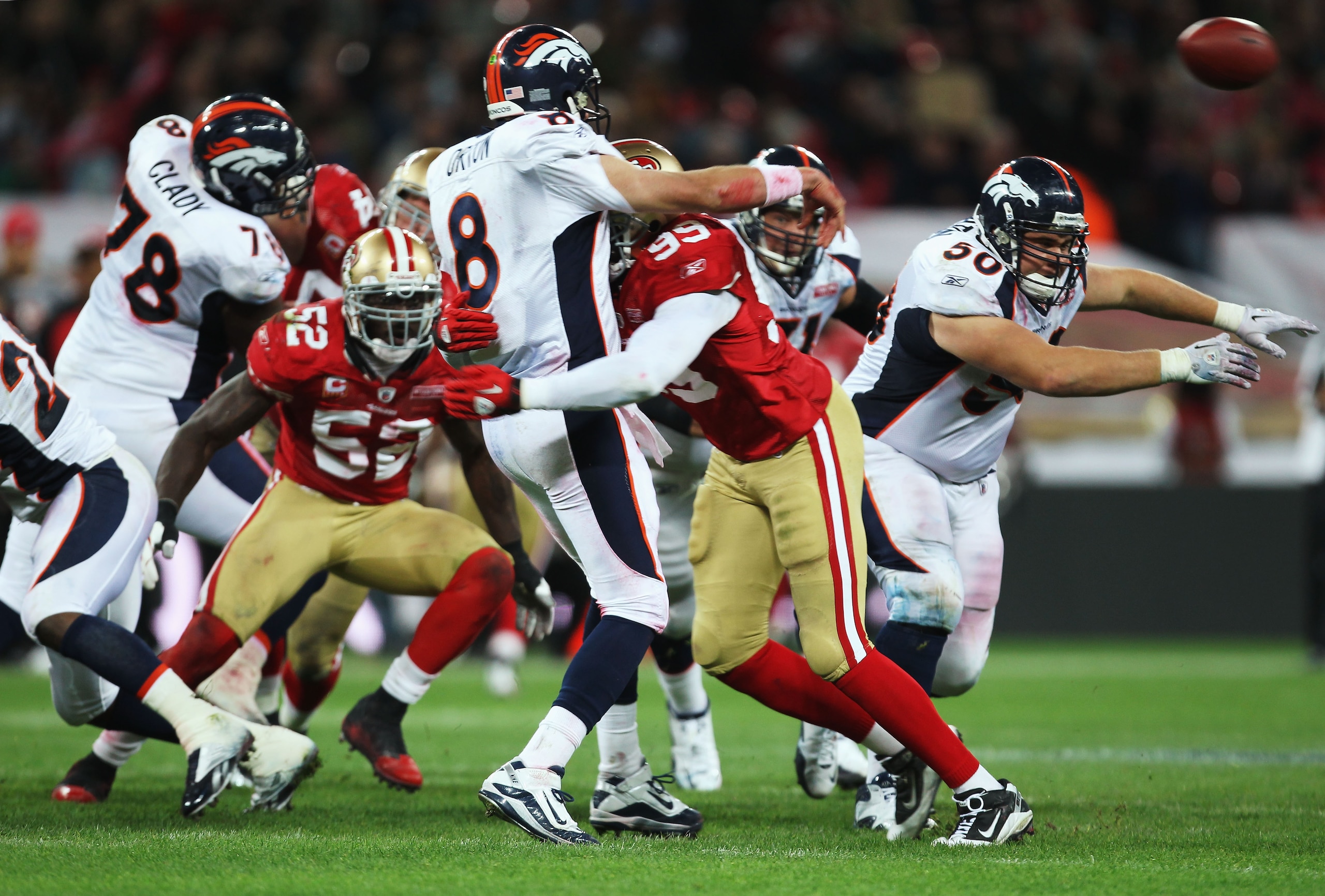 LONDON, ENGLAND - OCTOBER 31:  Kyle Orton #8 of Denver Broncos is tackled Manny Lawson #99 of San Francisco 49ers during the NFL International Series match between Denver Broncos and San Francisco 49ers at Wembley Stadium on October 31, 2010 in London, En