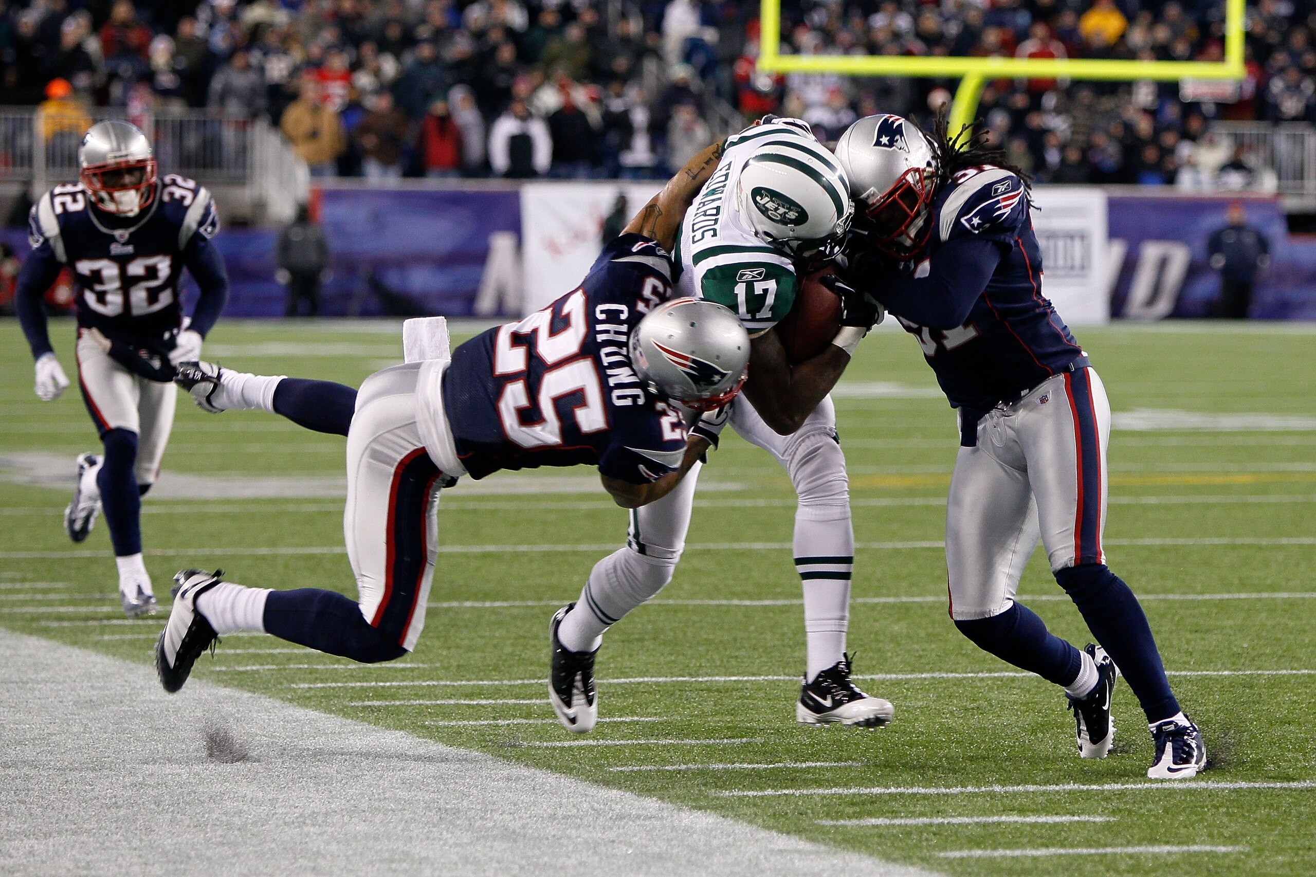 FOXBORO, MA - DECEMBER 06:  Braylon Edwards #17 of the New York Jets is hit as he runs for yards after the catch by Patrick Chung #25 and Brandon Meriweather #31 of the New England Patriots at Gillette Stadium on December 6, 2010 in Foxboro, Massachusetts